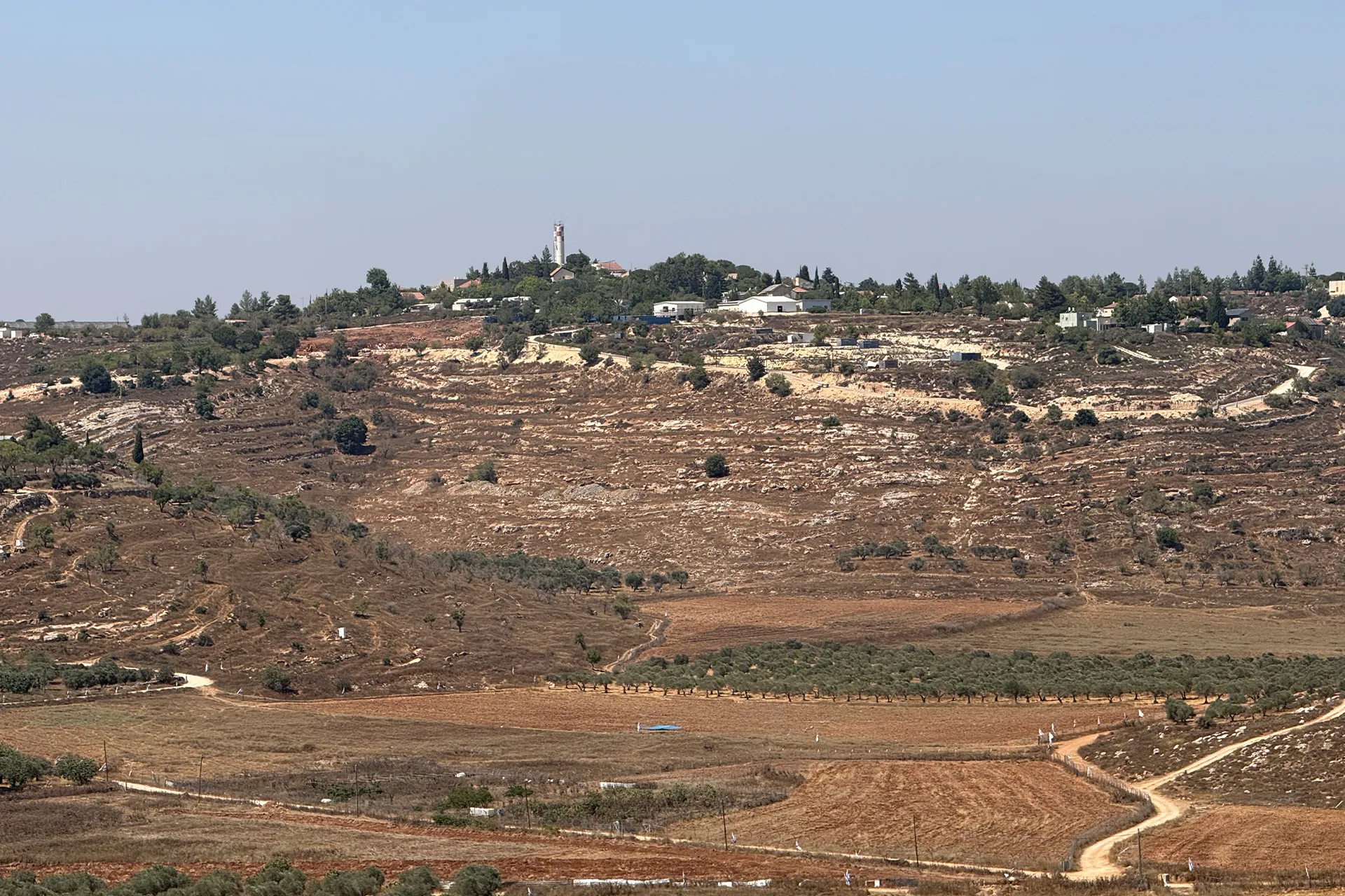 The illegal Israeli settlement of Shiloh, built on confiscated Palestinian land, physically encircles and suffocates the village of Jalud [Al Jazeera]