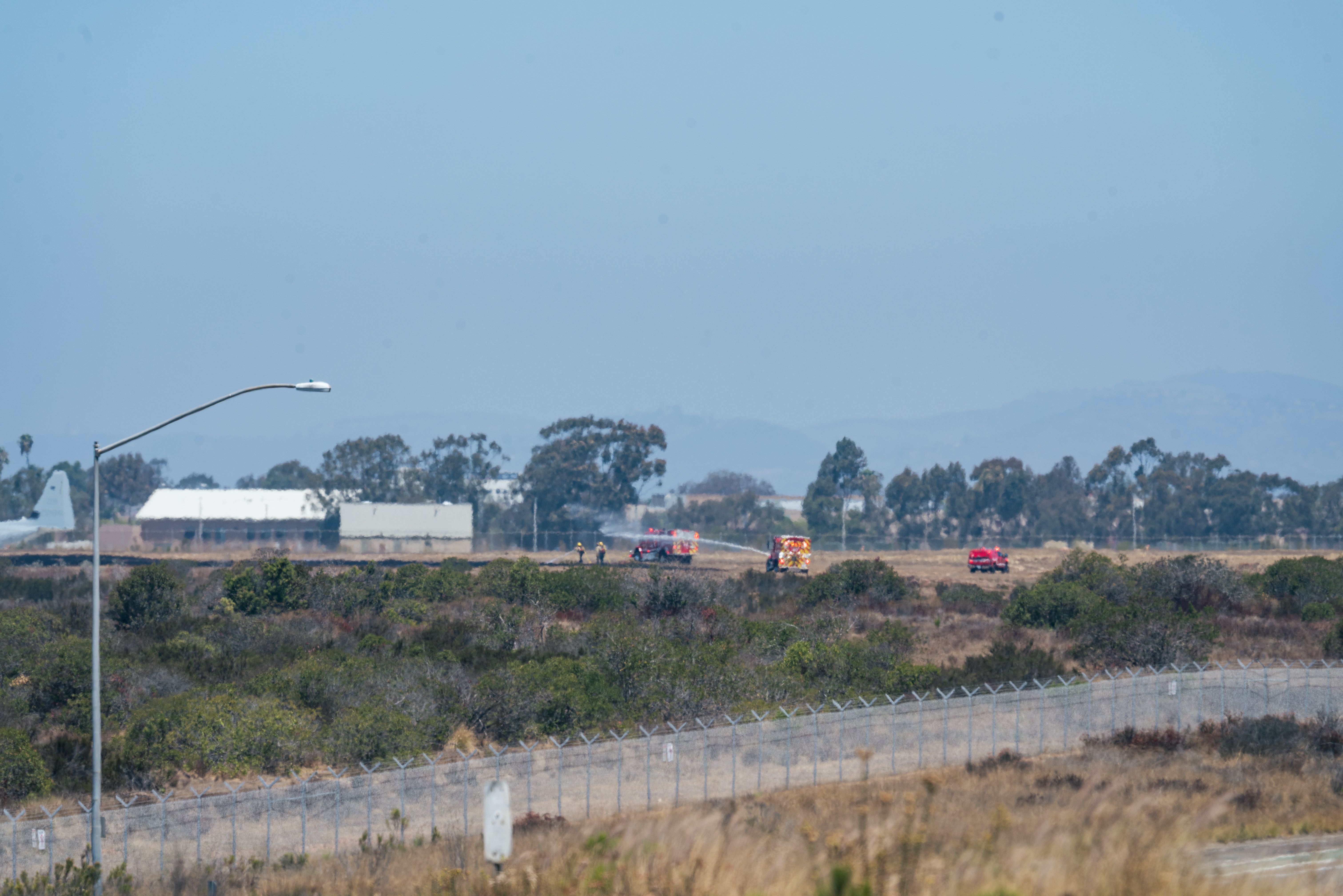 Emergency personnel respond near the site where a US Marine Corps F-35B Lightning II fighter jet crashed near Marine Corps Air Station Miramar in San Diego, California. [Jonathan Chang/EPA}