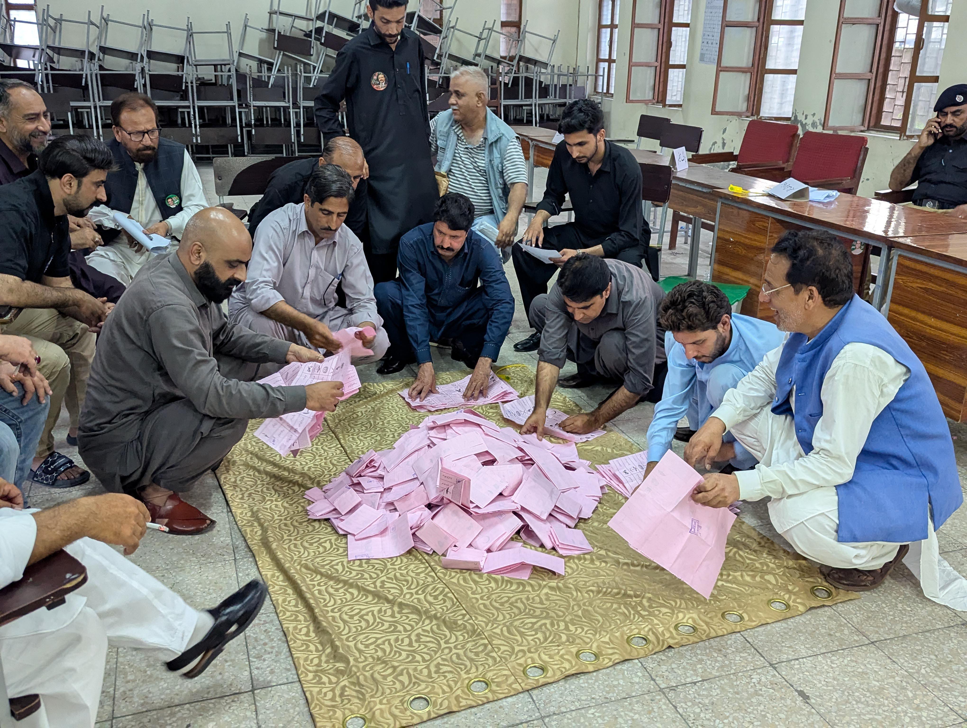 epa13147337 Election officials count ballots during the second phase of elections for the local legislative assembly in Muzaffarabad, Pakistan-administered Kashmir, 02 August 2026. Polling took place under heightened security amid a boycott and protests by the banned Jammu Kashmir Awami Joint Action Committee (JAAC) over governance issues and the allocation of refugee seats in the regional assembly. EPA/AMIRUDDIN MUGHAL