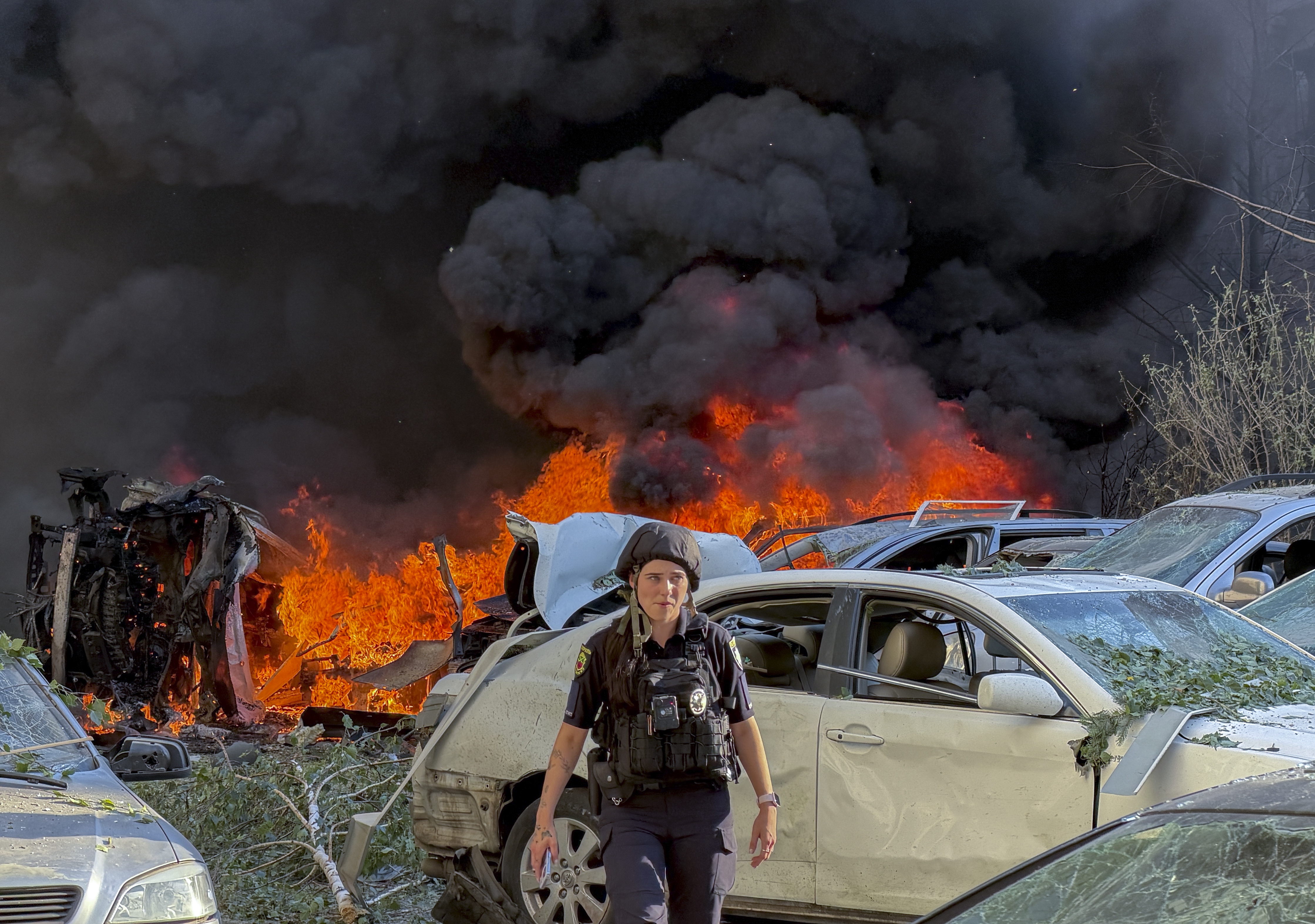 A police officer surveys the site of a Russian attack on residential area in Zaporizhzhia