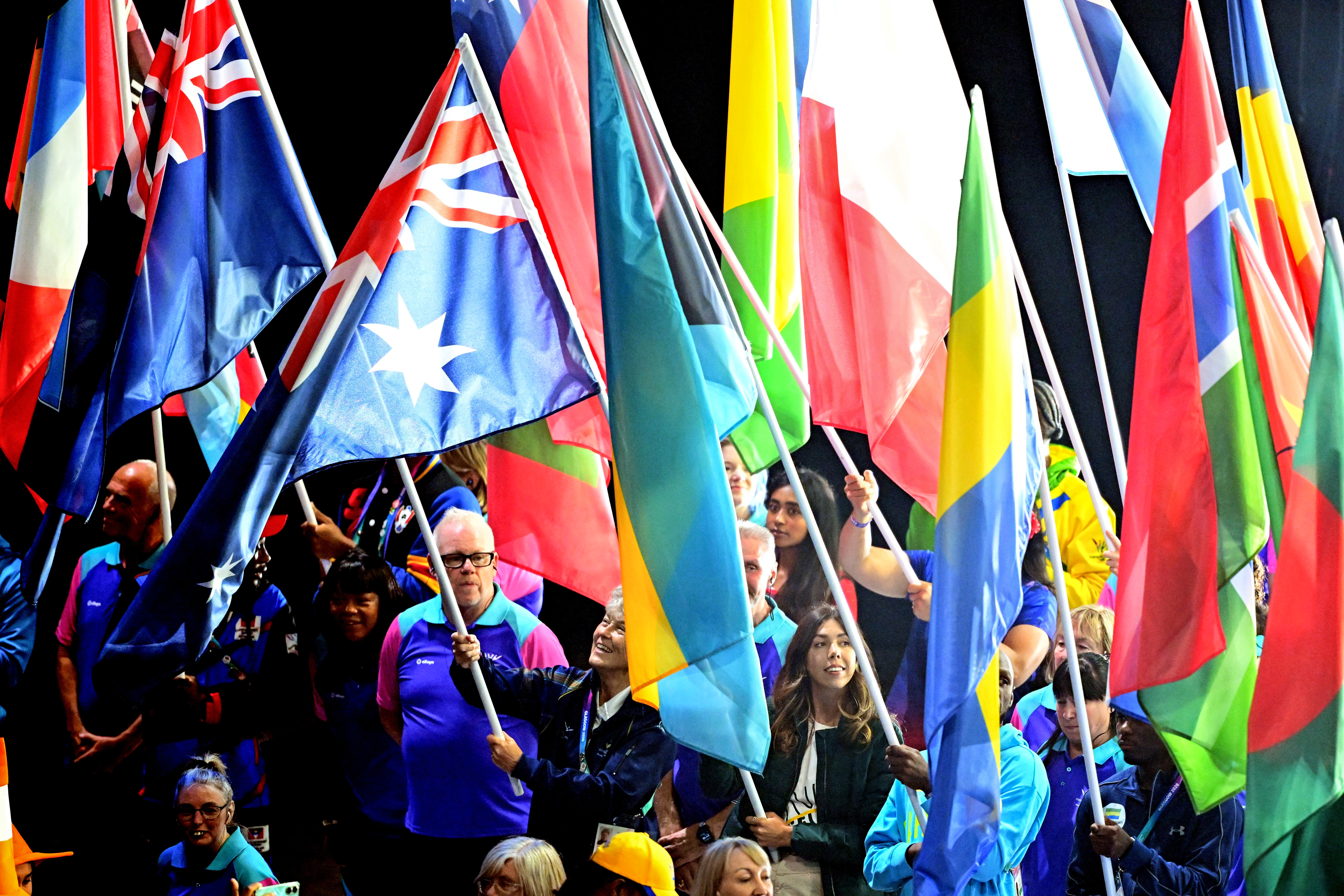 Athletes carry their country flags during the Closing Ceremony of the Glasgow 2026 Commonwealth Games at The Hydro in Glasgow, Scotland