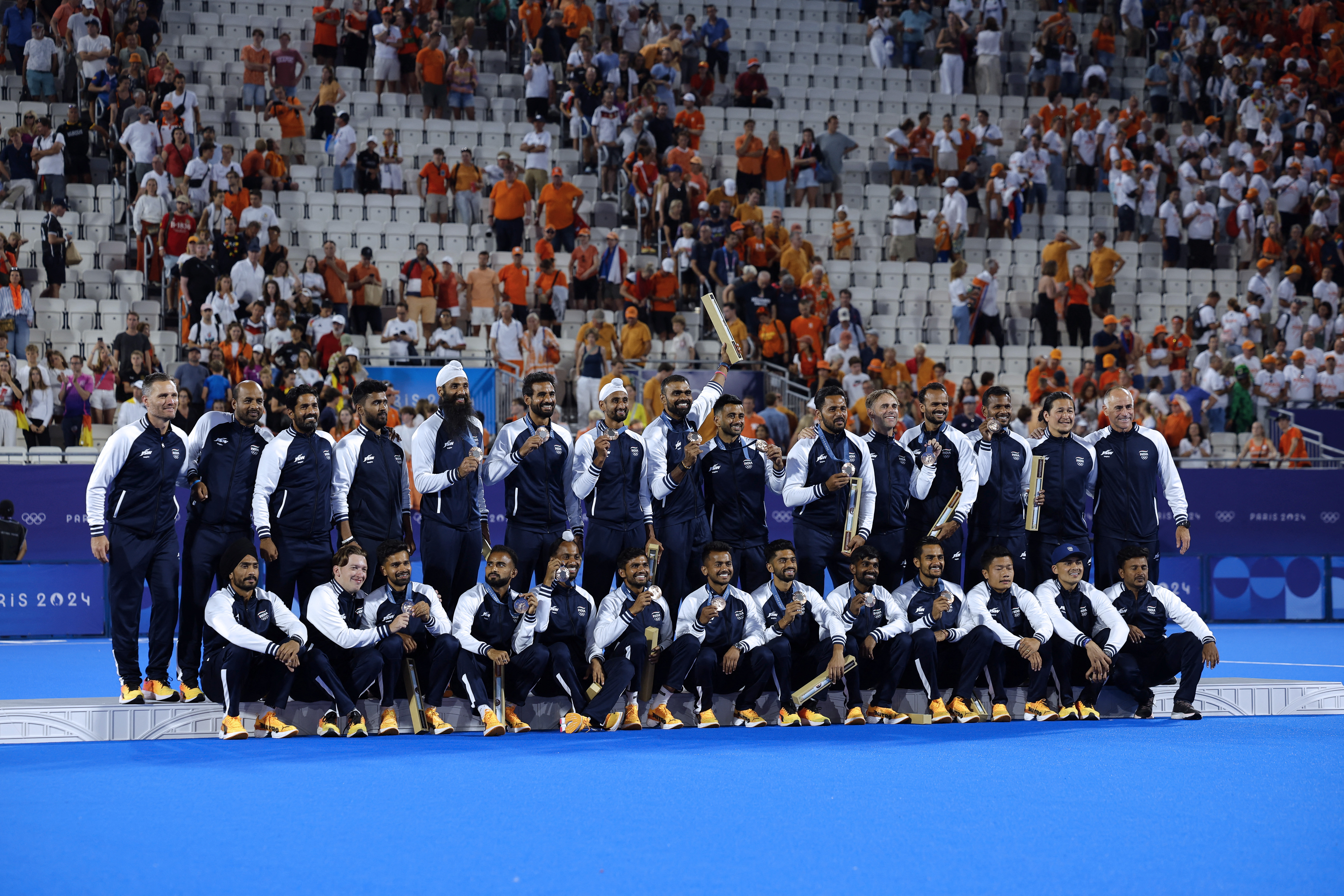 Paris 2024 Olympics - Hockey - Men's Victory Ceremony - Yves-du-Manoir Stadium, Colombes, France - August 08, 2024. Bronze medallists India celebrate on the podium. REUTERS/Anushree Fadnavis
