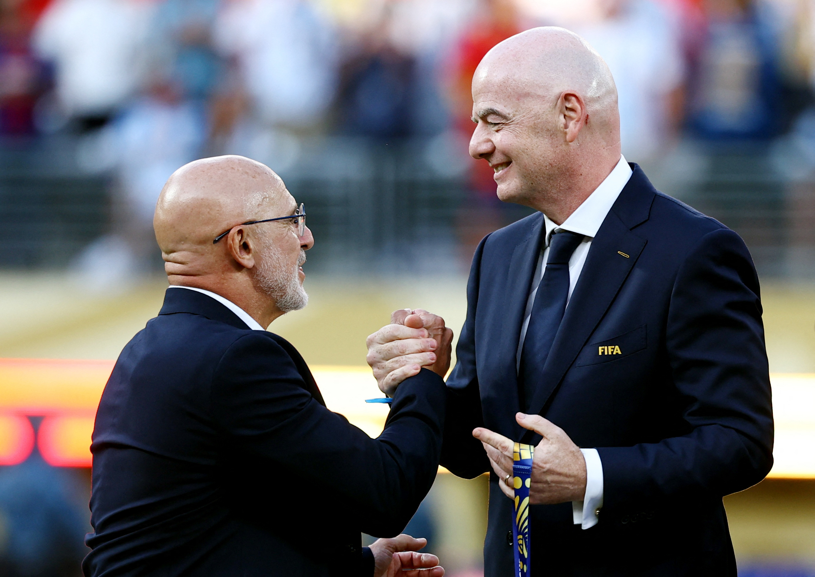 Spain coach Luis De La Fuente receives his medal from FIFA President Gianni Infantino.