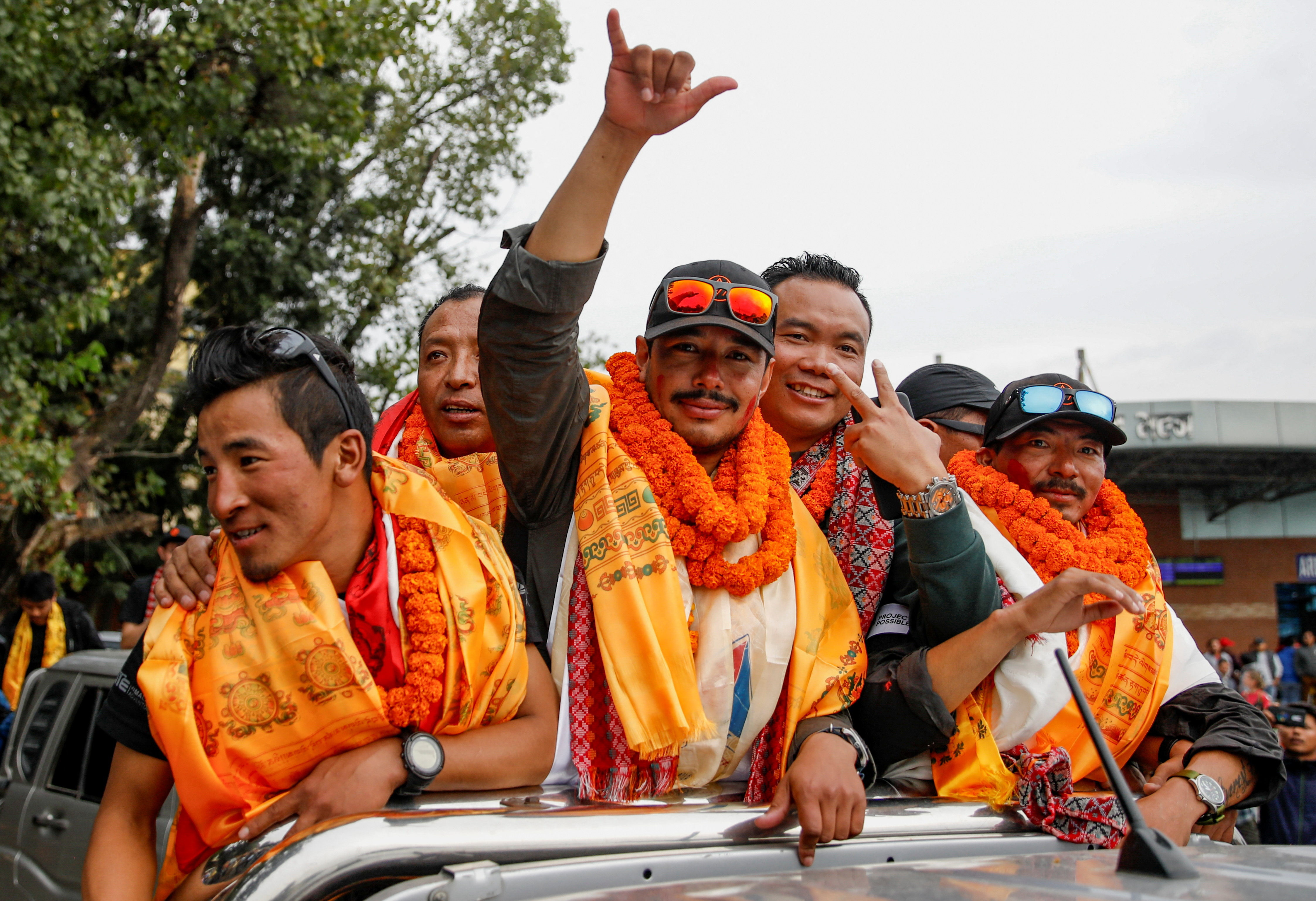 Nirmal Purja, who became the fastest person to summit the world's 14 highest mountains, gestures upon his arrival at Tribhuvan International Airport in Kathmandu, Nepal, October 30, 2019. Picture taken October 30, 2019. REUTERS/Navesh Chitrakar