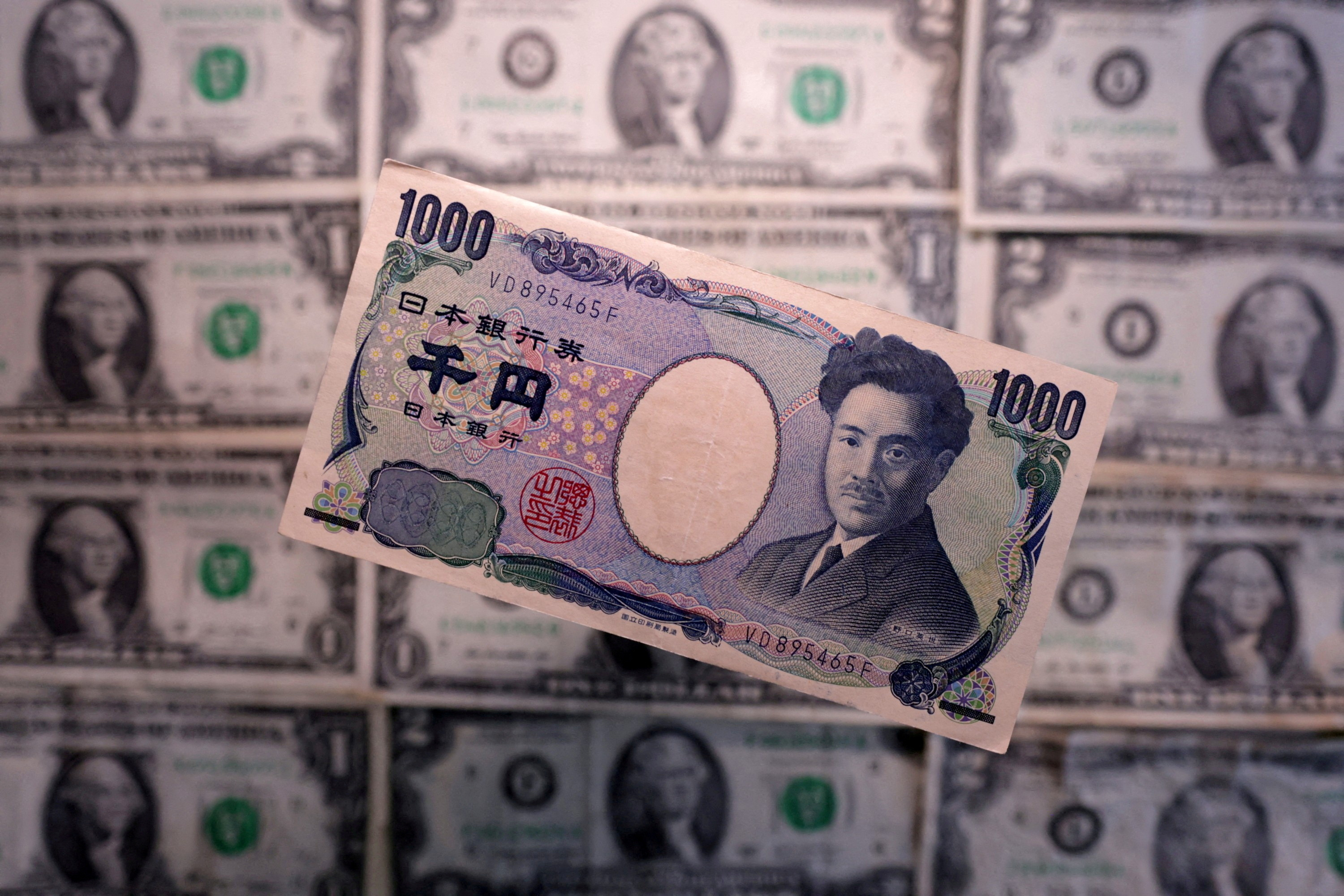 Yen and US dollar banknotes are seen.