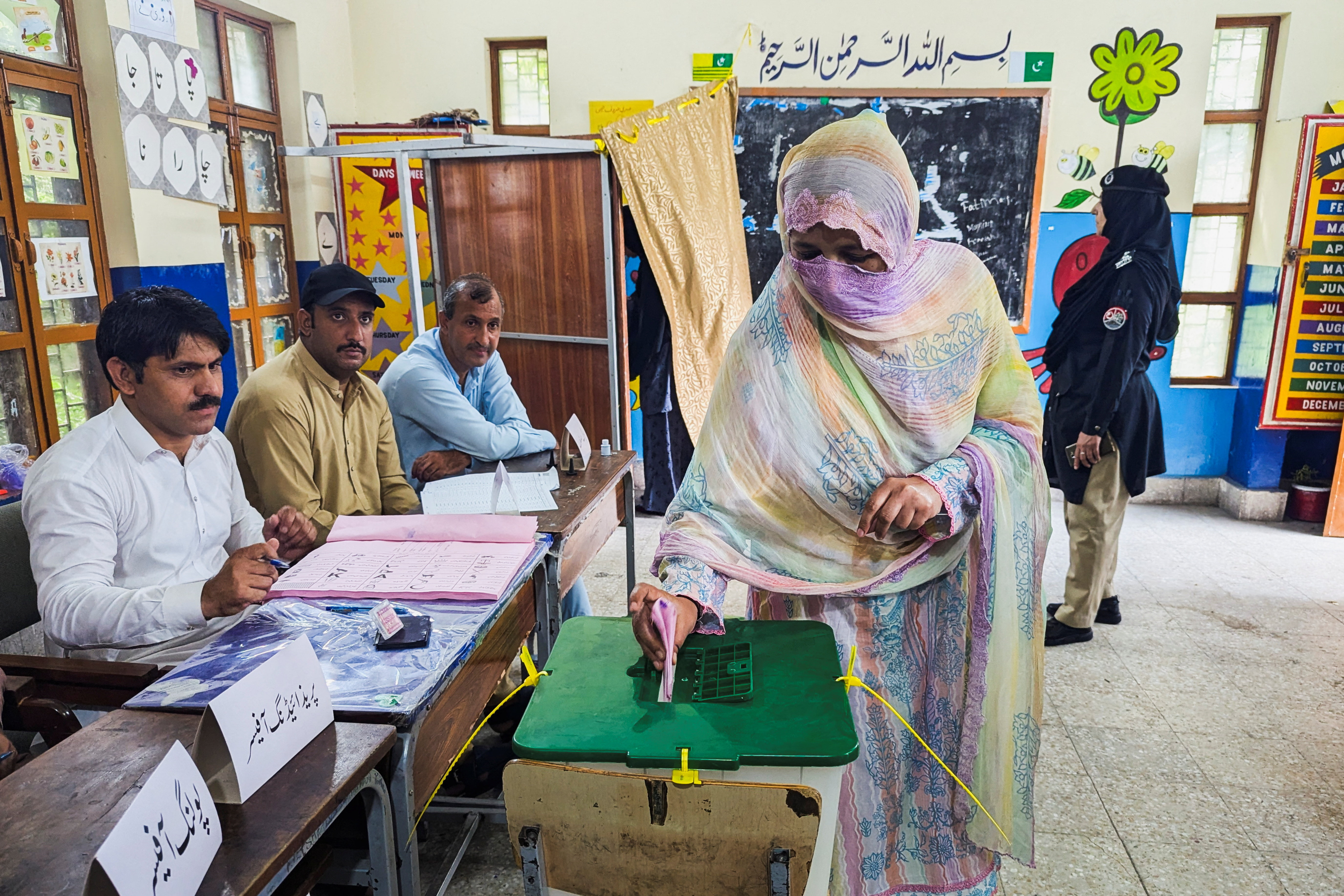 A woman votes during the second phase of the Azad Jammu and Kashmir (AJK) Legislative Assembly elections at a polling station in Muzaffarabad, Pakistan, August 2, 2026. Picture taken with a mobile phone. REUTERS/Stringer