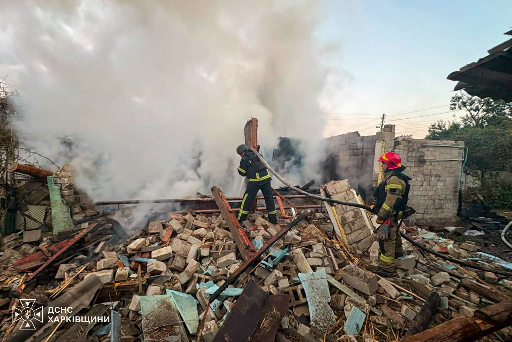 Firefighters work at the site of a house destroyed during overnight Russian drone strikes in the town of Balakliia, in Kharkiv region, Ukraine