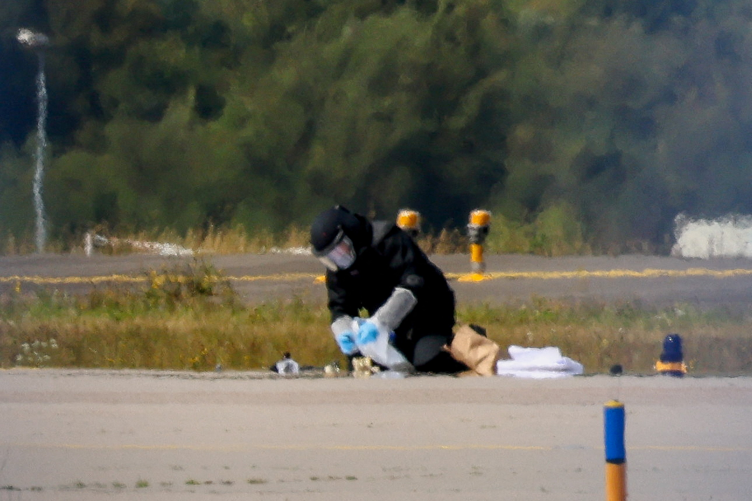 A police officer in protective clothing works at Leipzig/Halle Airport in Schkeuditz, Germany
