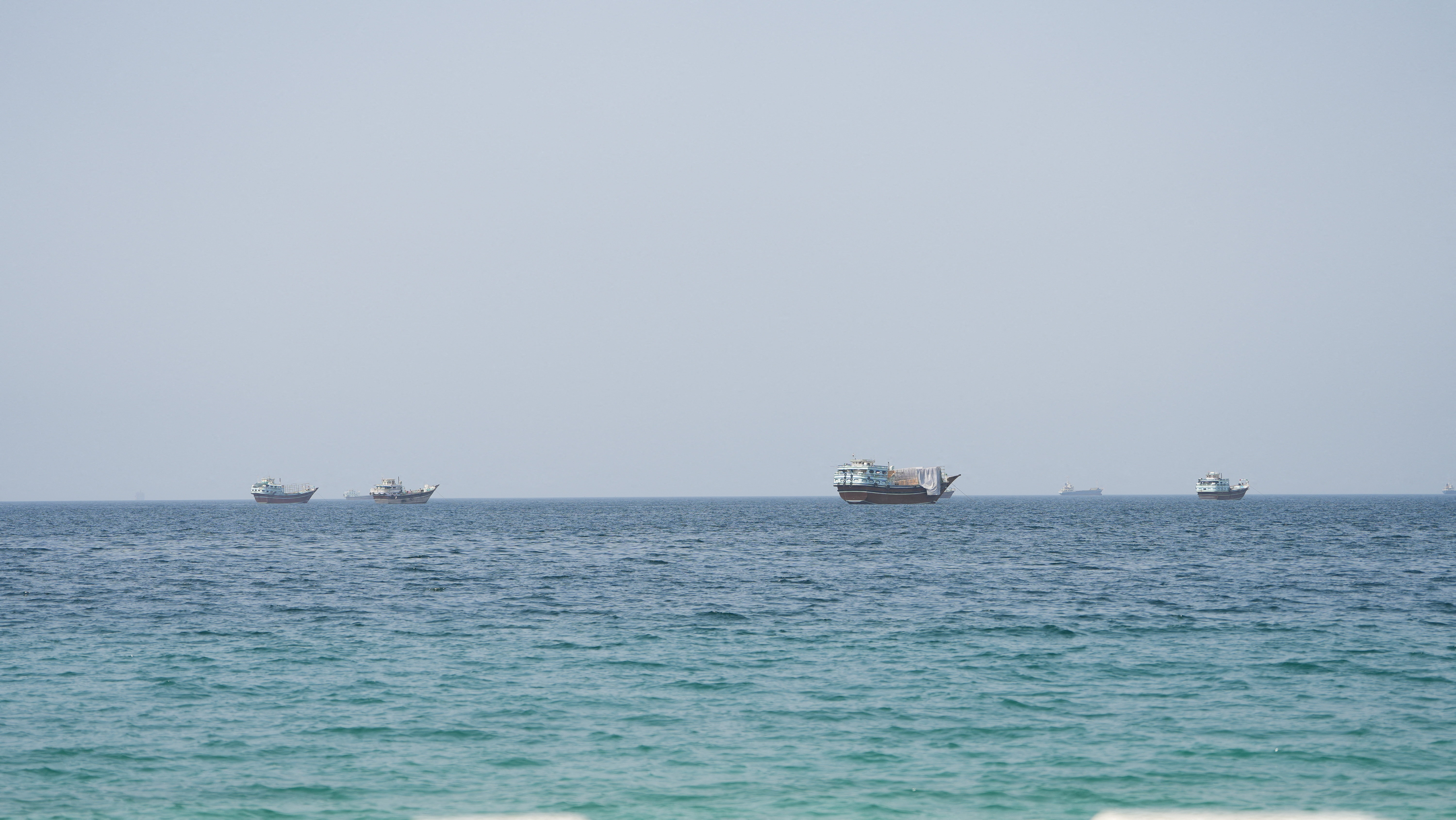 Vessels near the Strait of Hormuz, as seen from Musandam, Oman, August 6, 2026. [Reuters]