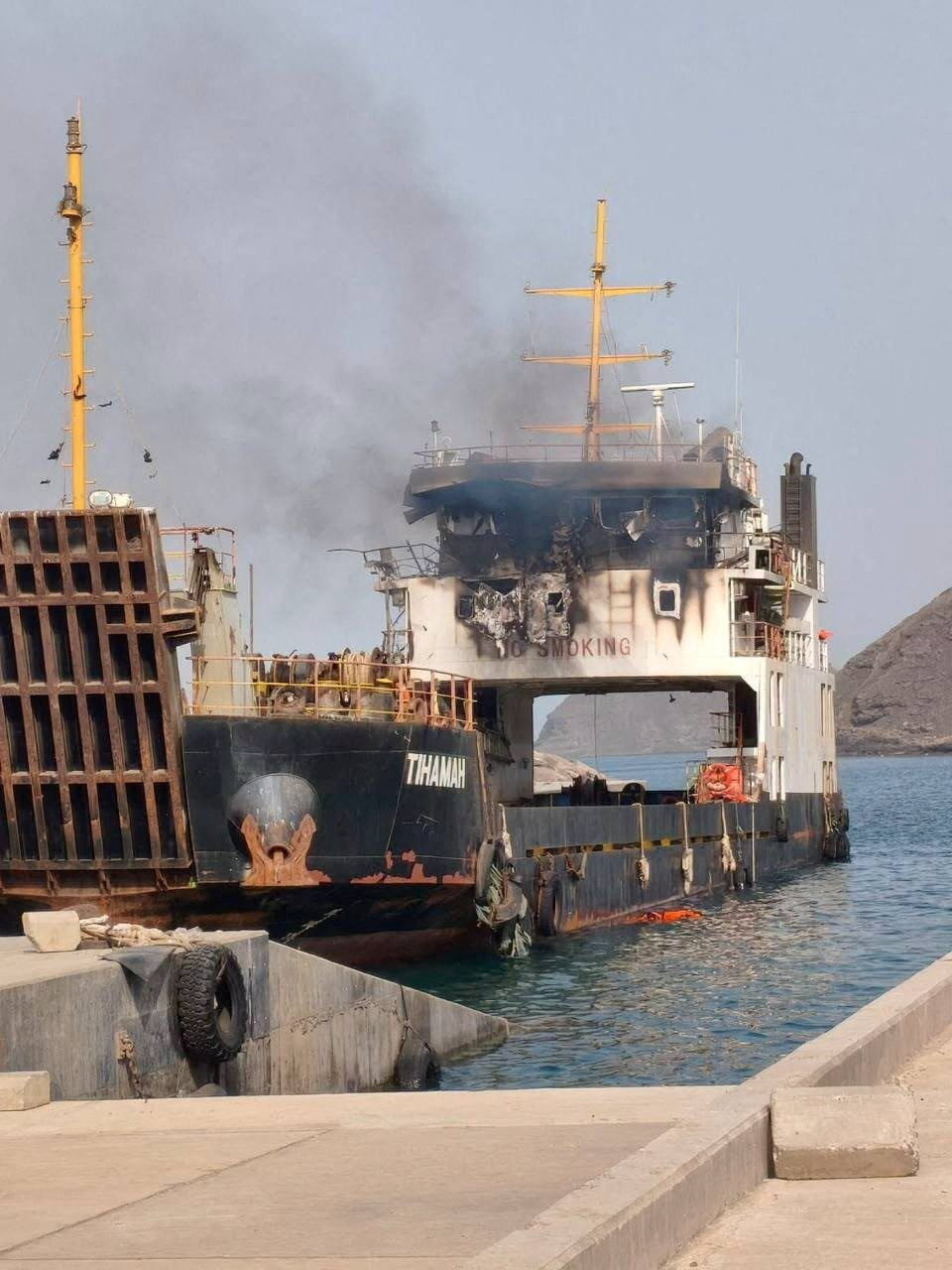 Smoke rising from a damaged cargo ship