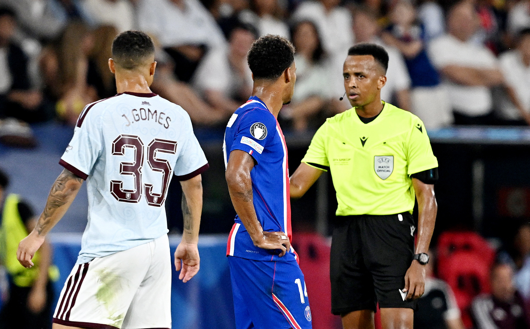 Paris St Germain's Desire Doue with referee Omar Artan during a VAR review leading to his goal being awarded
