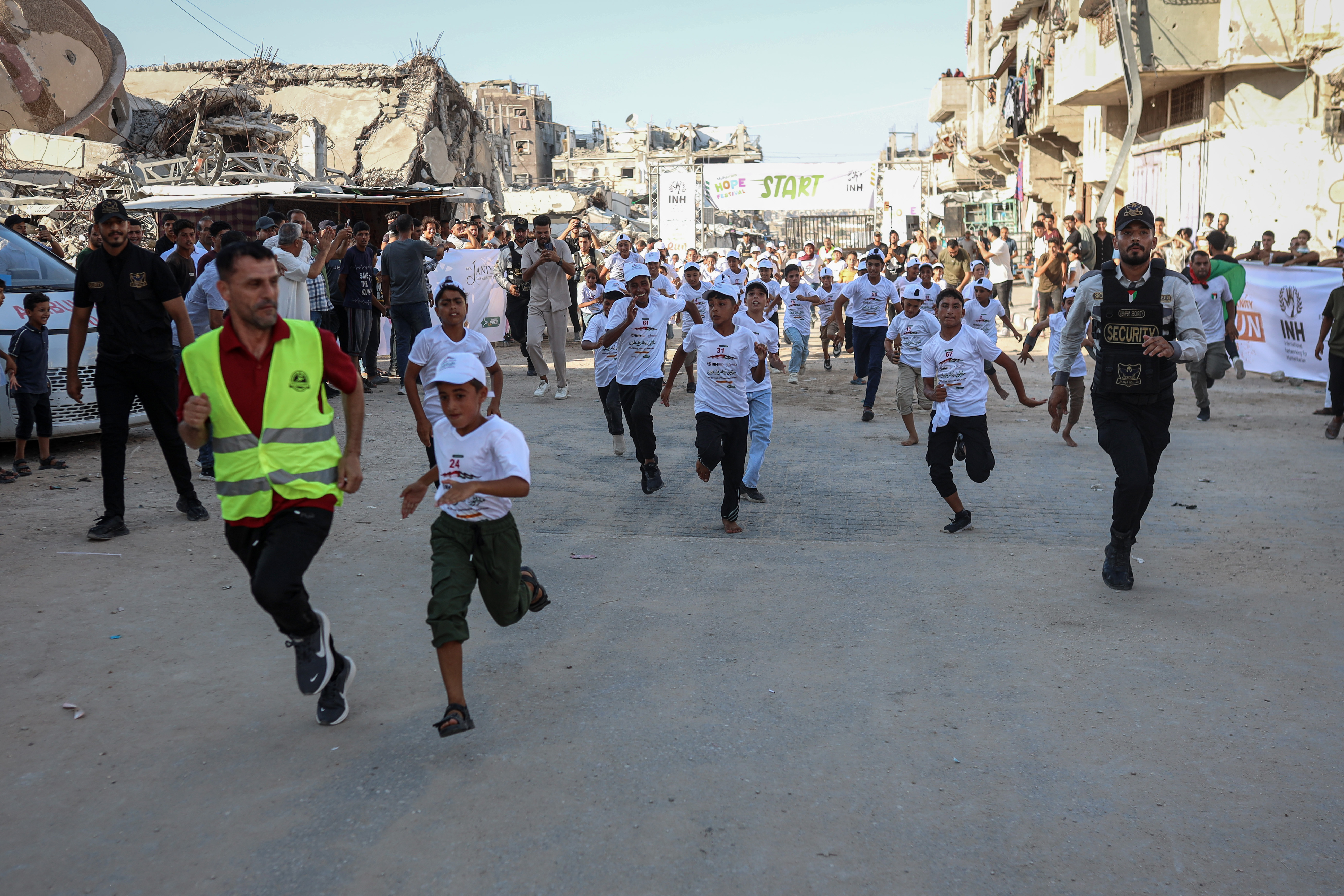 Children run in an orphan marathon organised in Gaza to raise awareness of the rights of orphaned children and the hardships they and their families face during the war [Abdelhakim Abu Riash/ Al Jazeera]