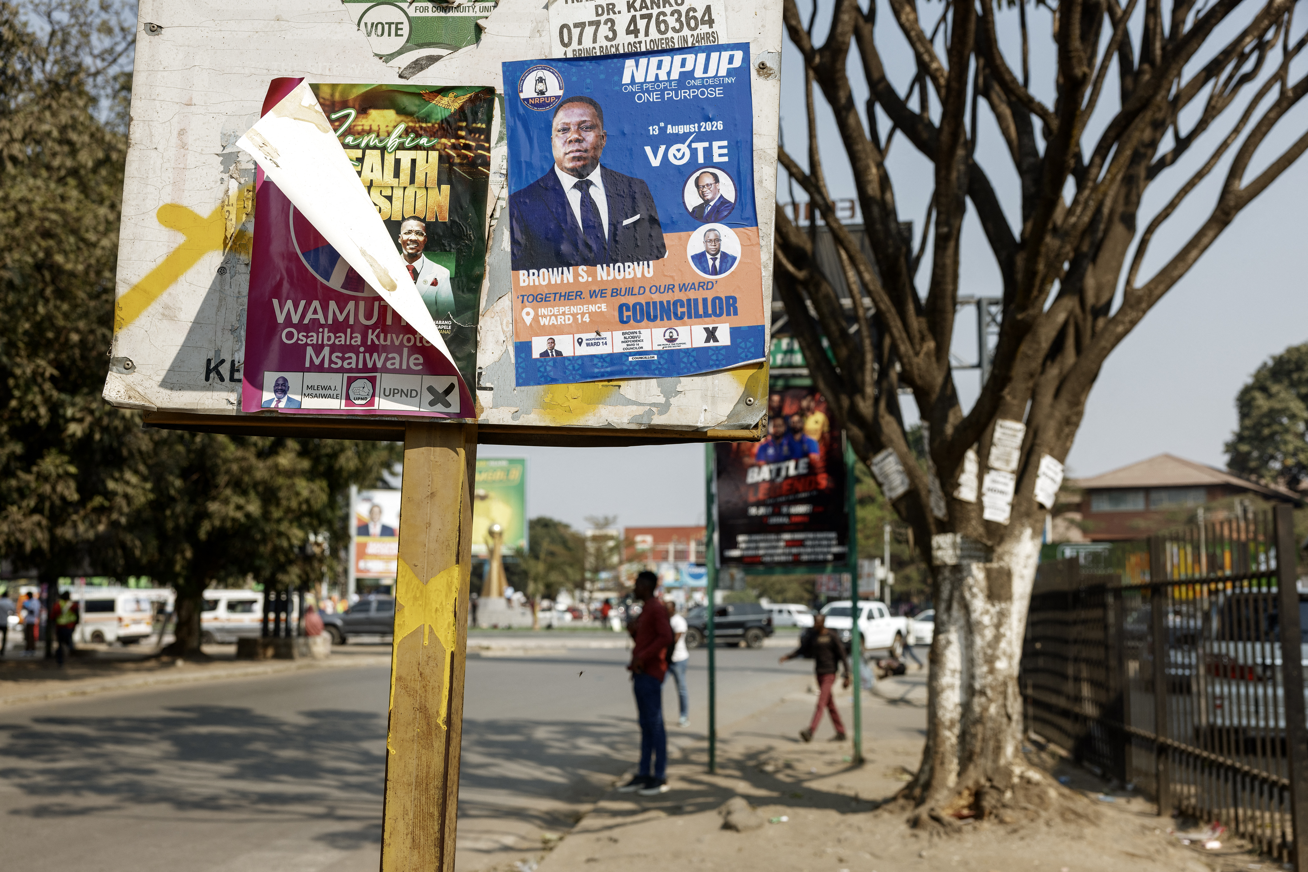 Posters of candidates are seen in a street.