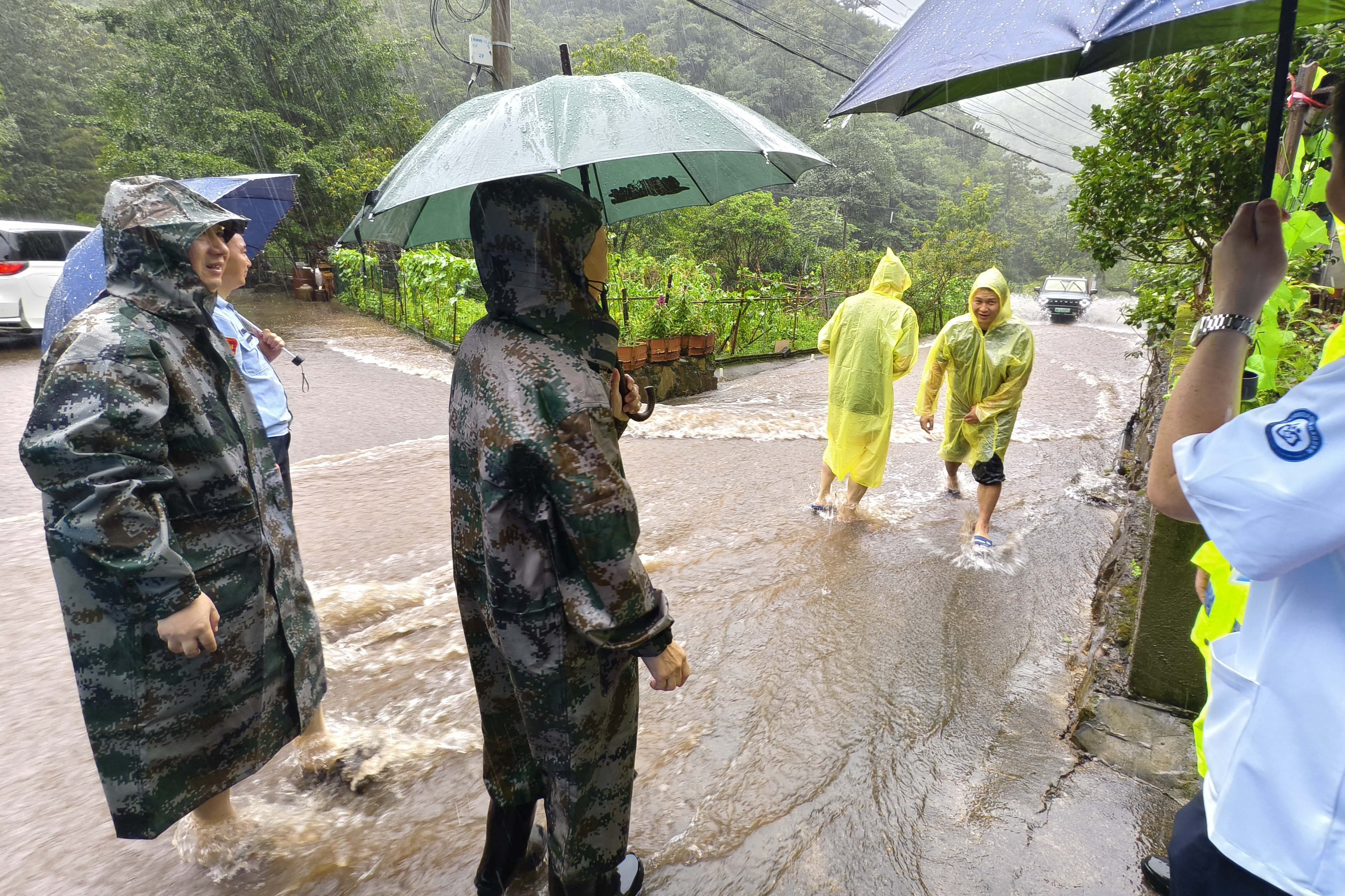 Officials help evacuate local residents in Lin'an district in Hangzhou, eastern China's Zhejiang province