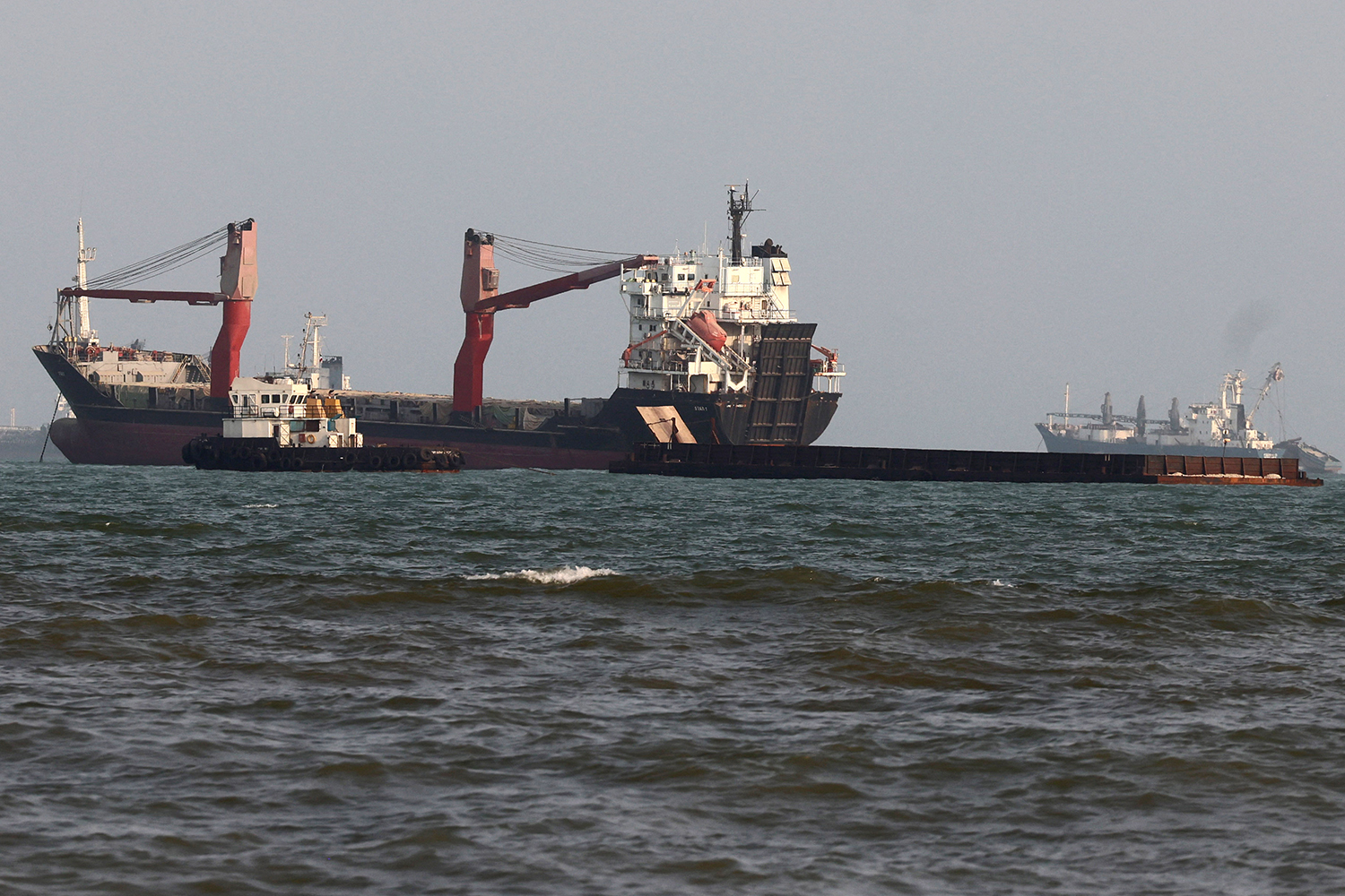 Vessels are seen in the Strait of Hormuz, off the port city of Bandar Abbas in southern Iran on August 10, 2026. The US President signalled on August 9 that he was prepared to let economic pressure mount against Iran, apparently backing away from more military strikes after Tehran issued a list of demands for opening the Strait of Hormuz. His remarks came after Iran issued over the weekend a list of conditions to reopen the Strait of Hormuz, which has remained largely closed since the start of the Middle East war in late February. (Photo by Atta KENARE / AFP) /