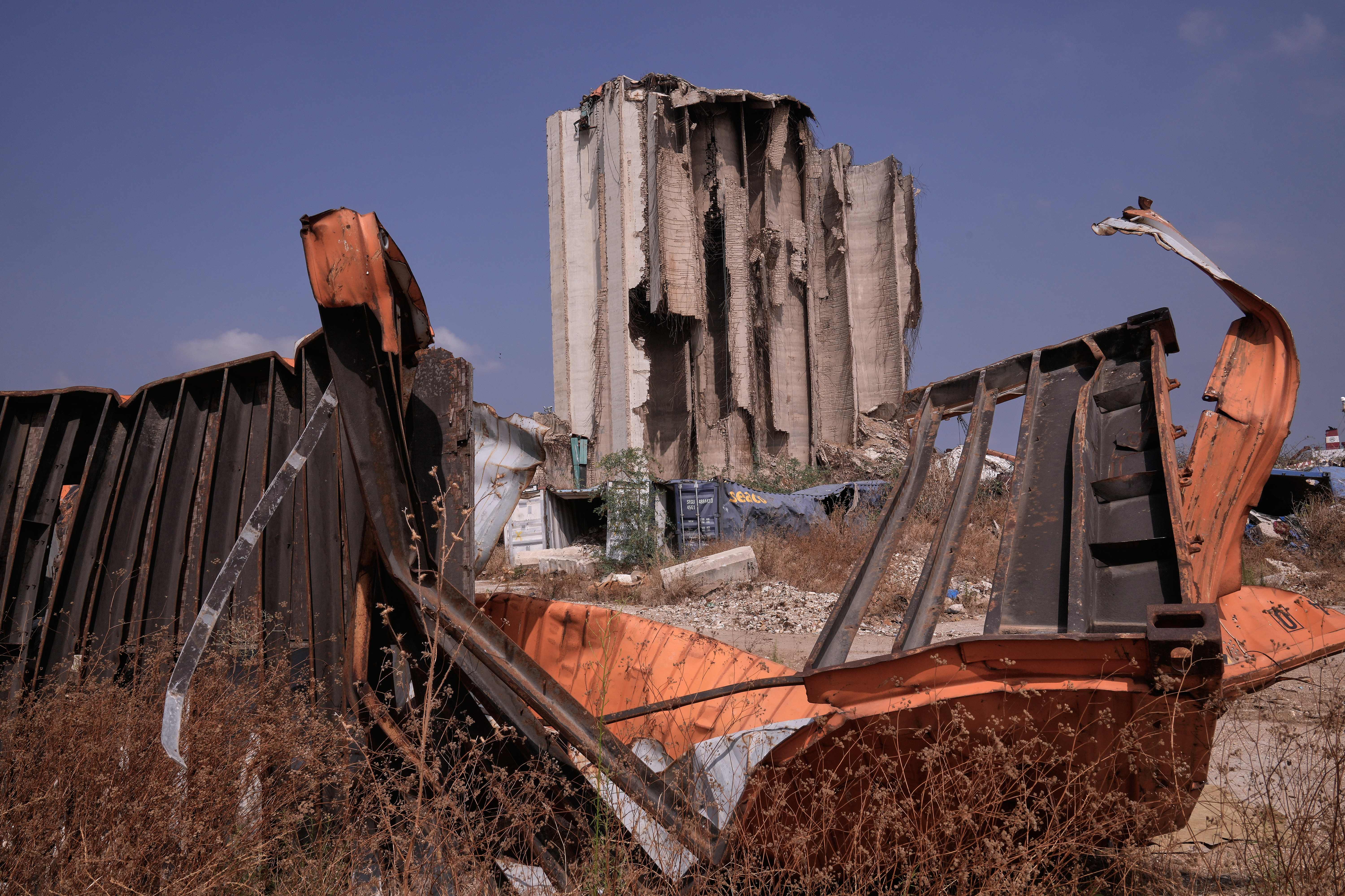 Rubble and debris are seen in front of towering grain silos that were gutted the deadly Aug. 4, 2020 Beirut explosion, during the sixth anniversary of the massive blast at the site of the explosion in Beirut's port, Lebanon, Tuesday, Aug. 4, 2026. (AP Photo/Hussein Malla)