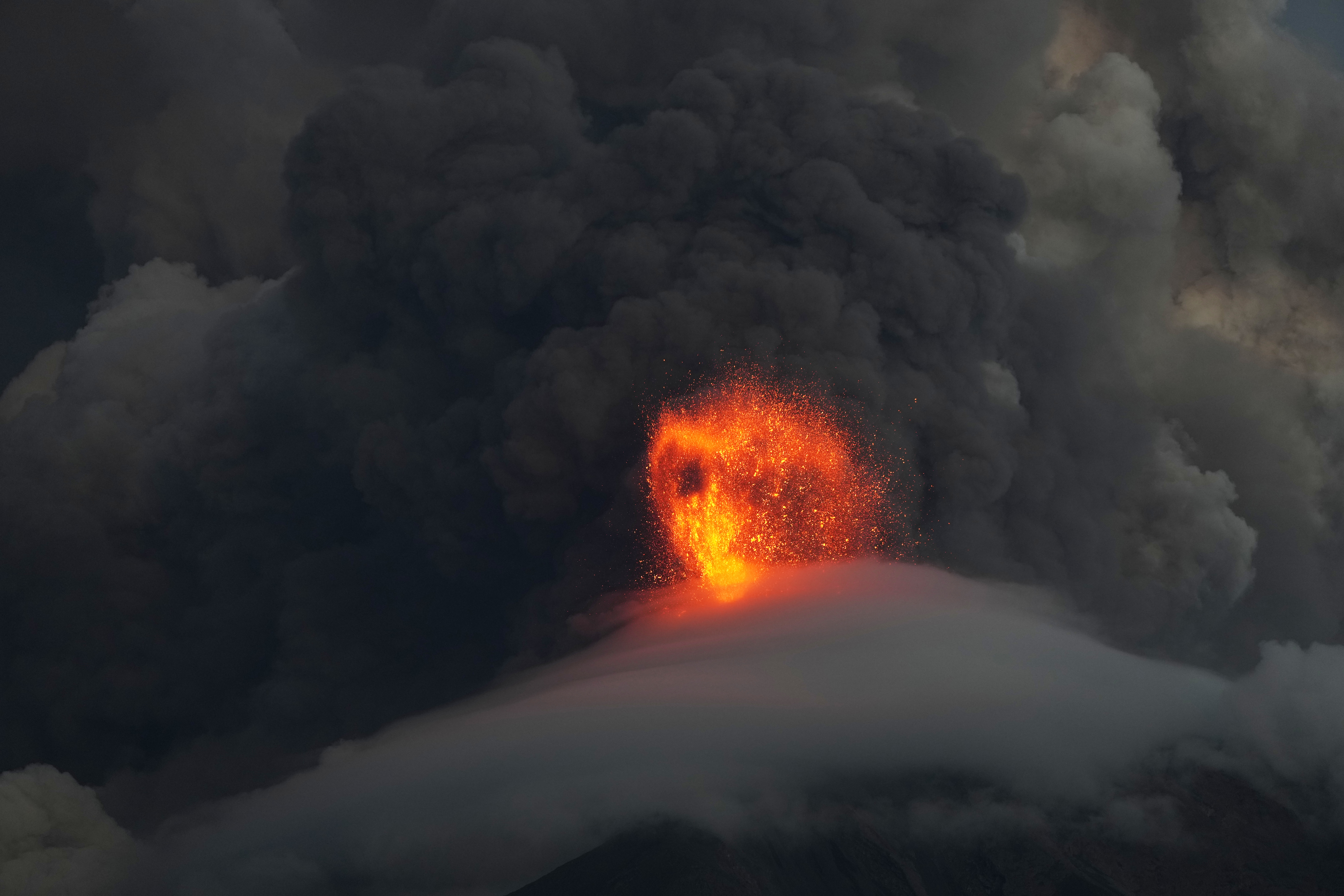 Lava flows out of the crater of the Fuego Volcano