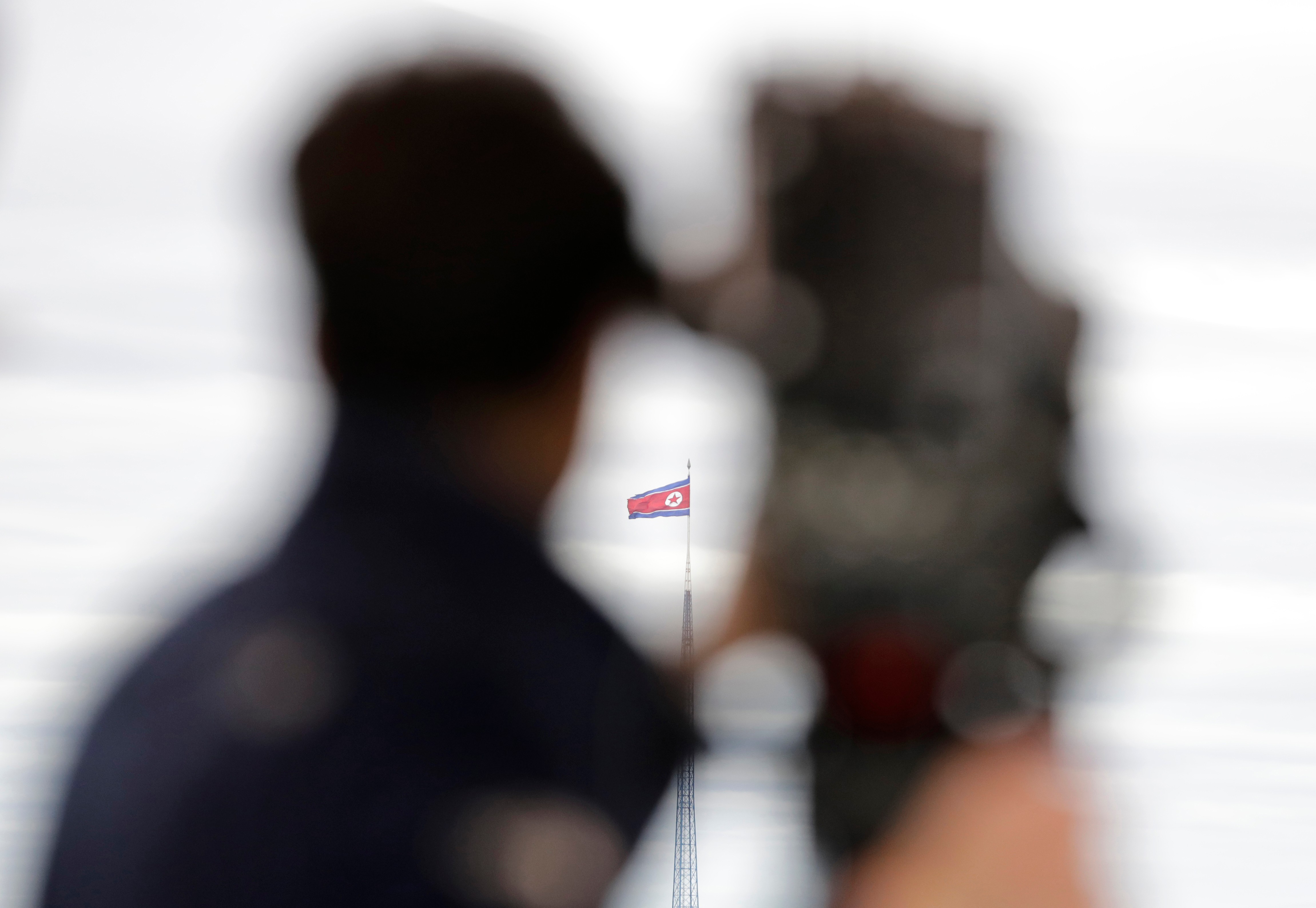 A North Korean flag flutters in the wind atop a 160-meter tower in North Korea's village Gijungdong as seen from the Taesungdong freedom village inside the demilitarized zone