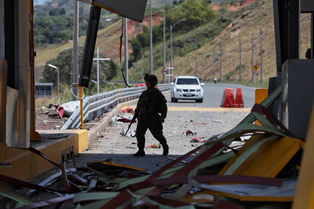 A soldier walks in the area of an explosives attack