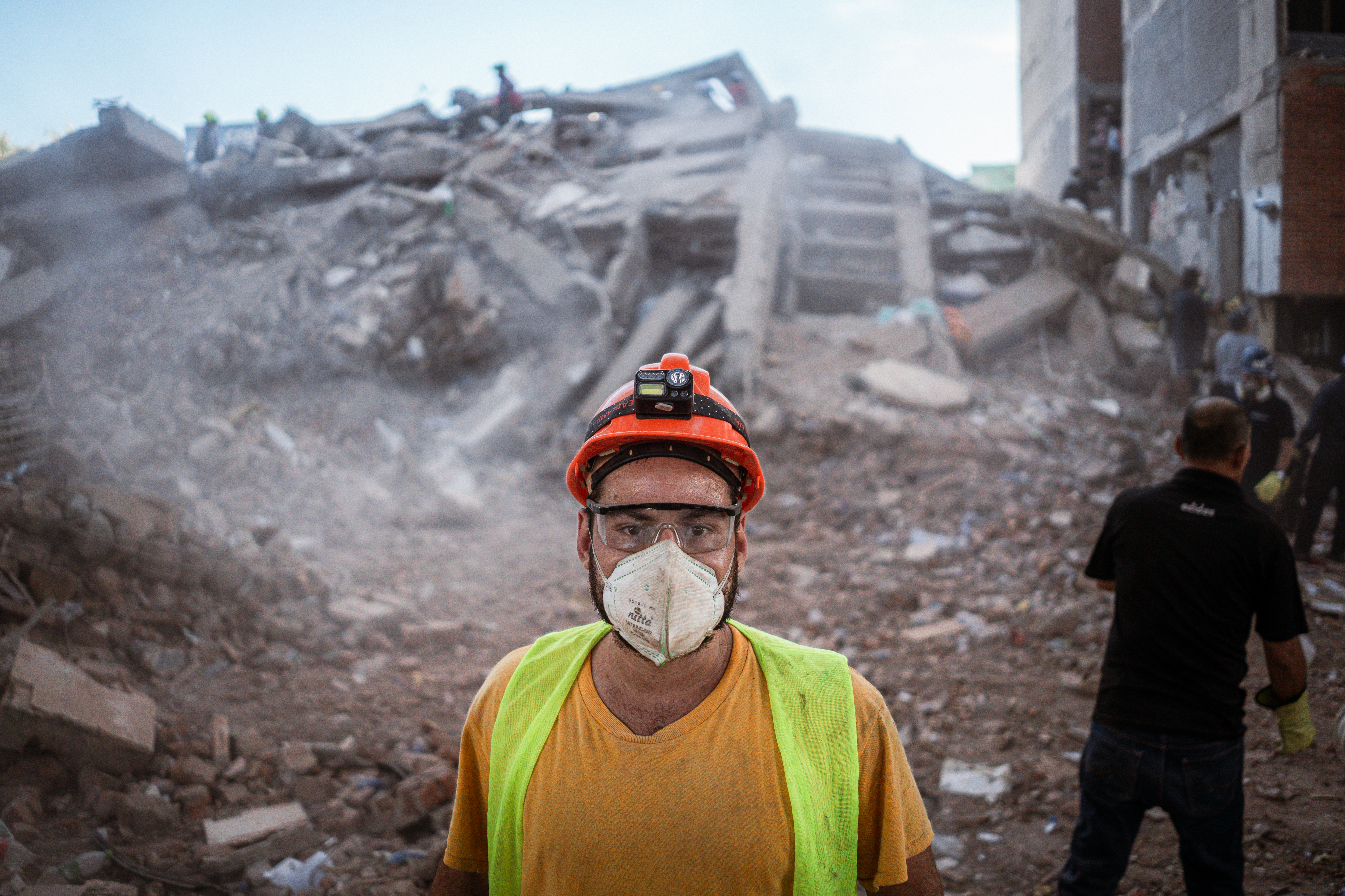 Maximiliano Herrera, 32, a volunteer rescuer, pictured in front of the wreckage of the Vanessa apartment building in Cali, Colombia. [Euan Wallace / Al Jazeera]