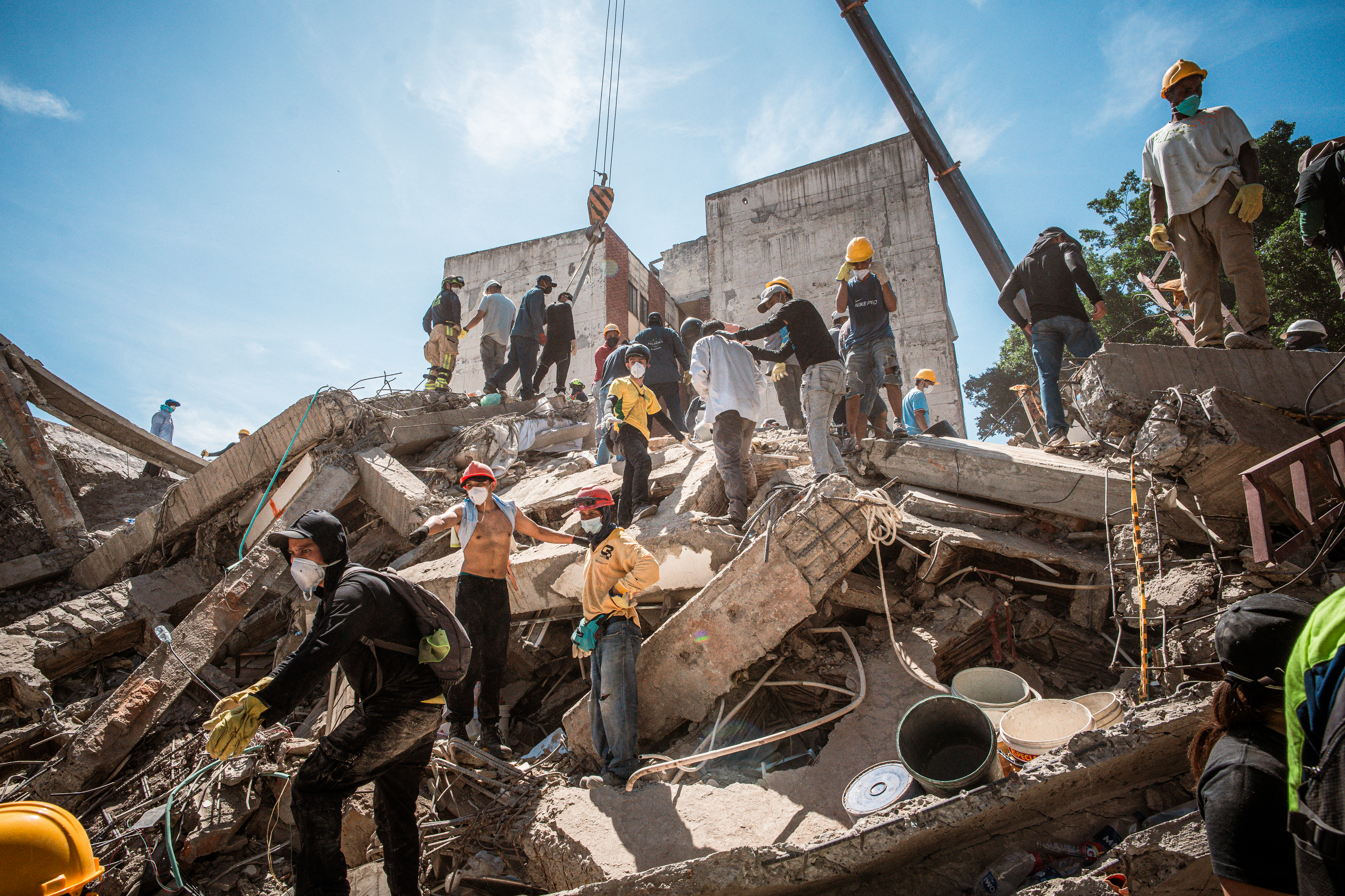 Local volunteers rush to clear the wreckage of the Vanessa apartment building in Cali, Colombia. [Euan Wallace/Al Jazeera]