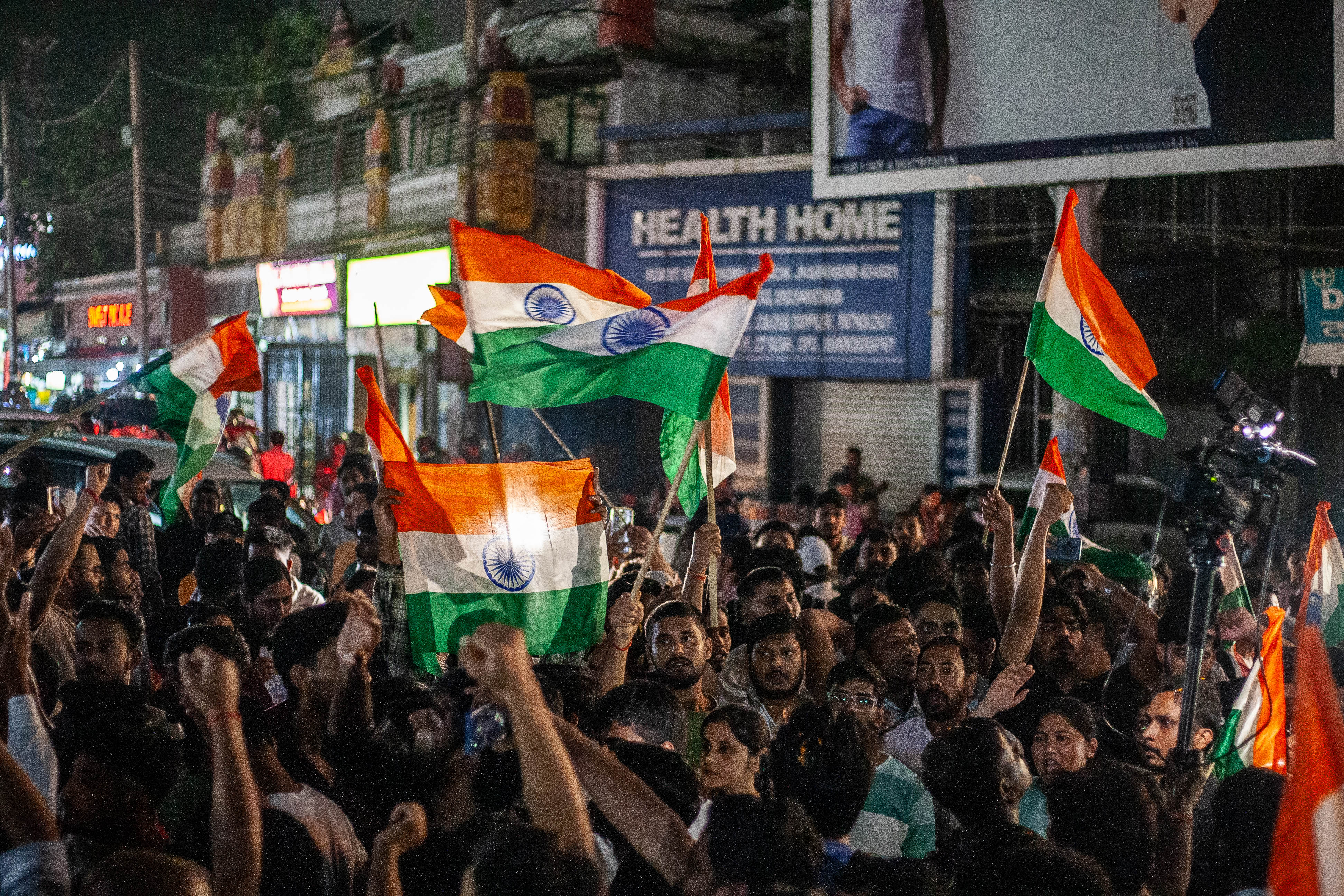 A large crowd of protesters marches towards Albert Ekka Chowk carrying Indian national flags during a demonstration