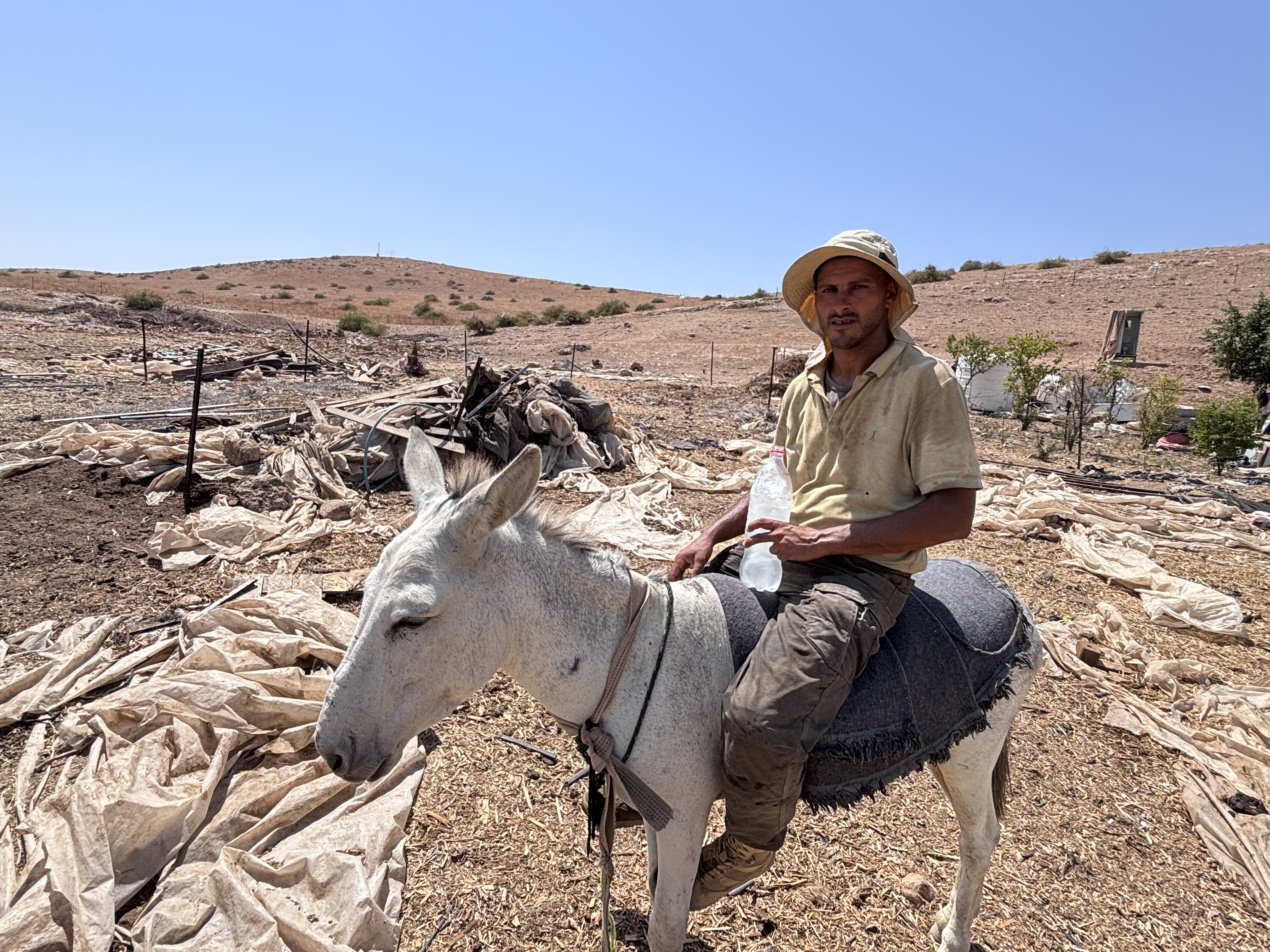 Hilal Daraghmeh in front of his destroyed home