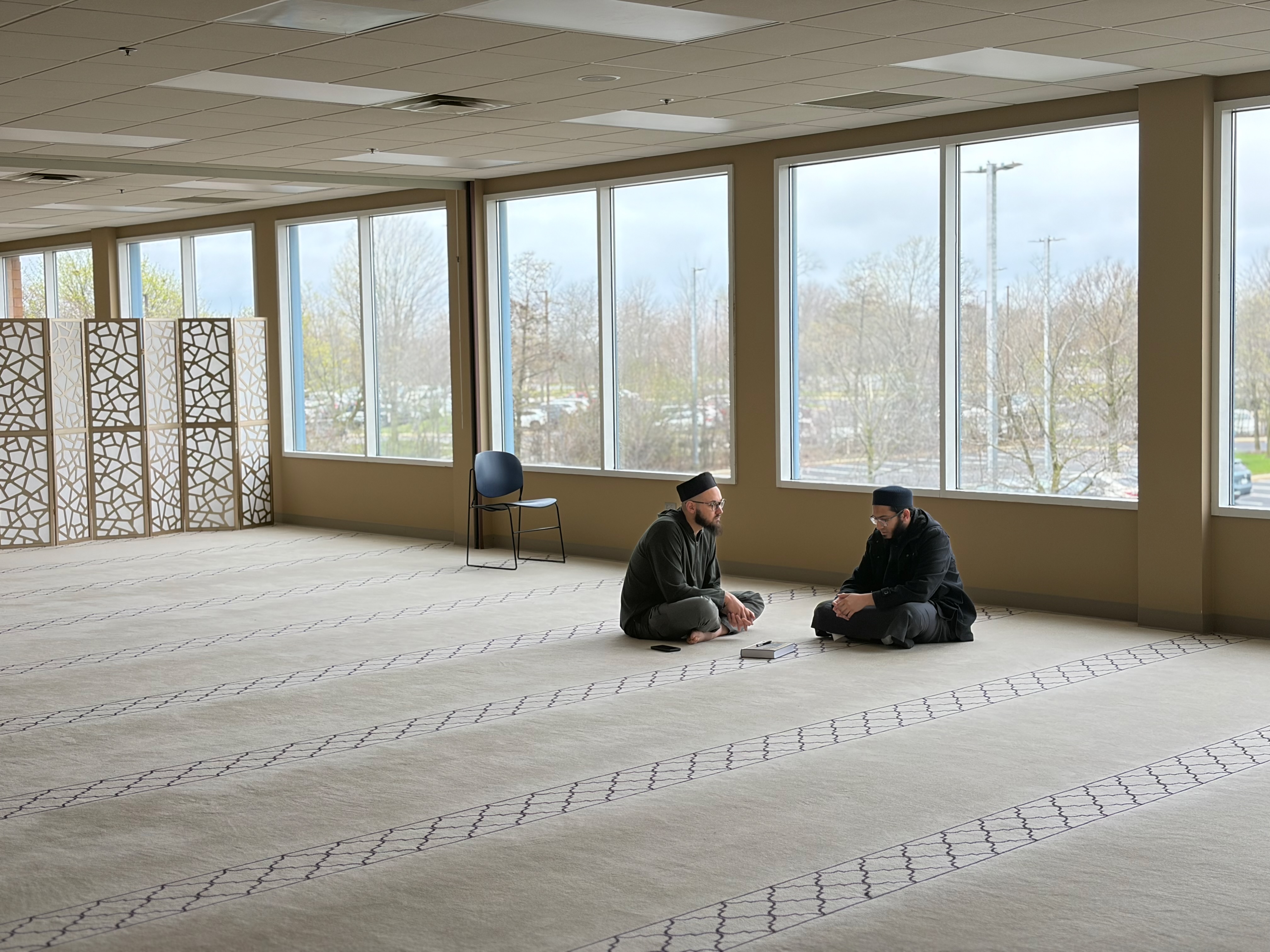 Two students in conversation after prayer at Darul Qasim