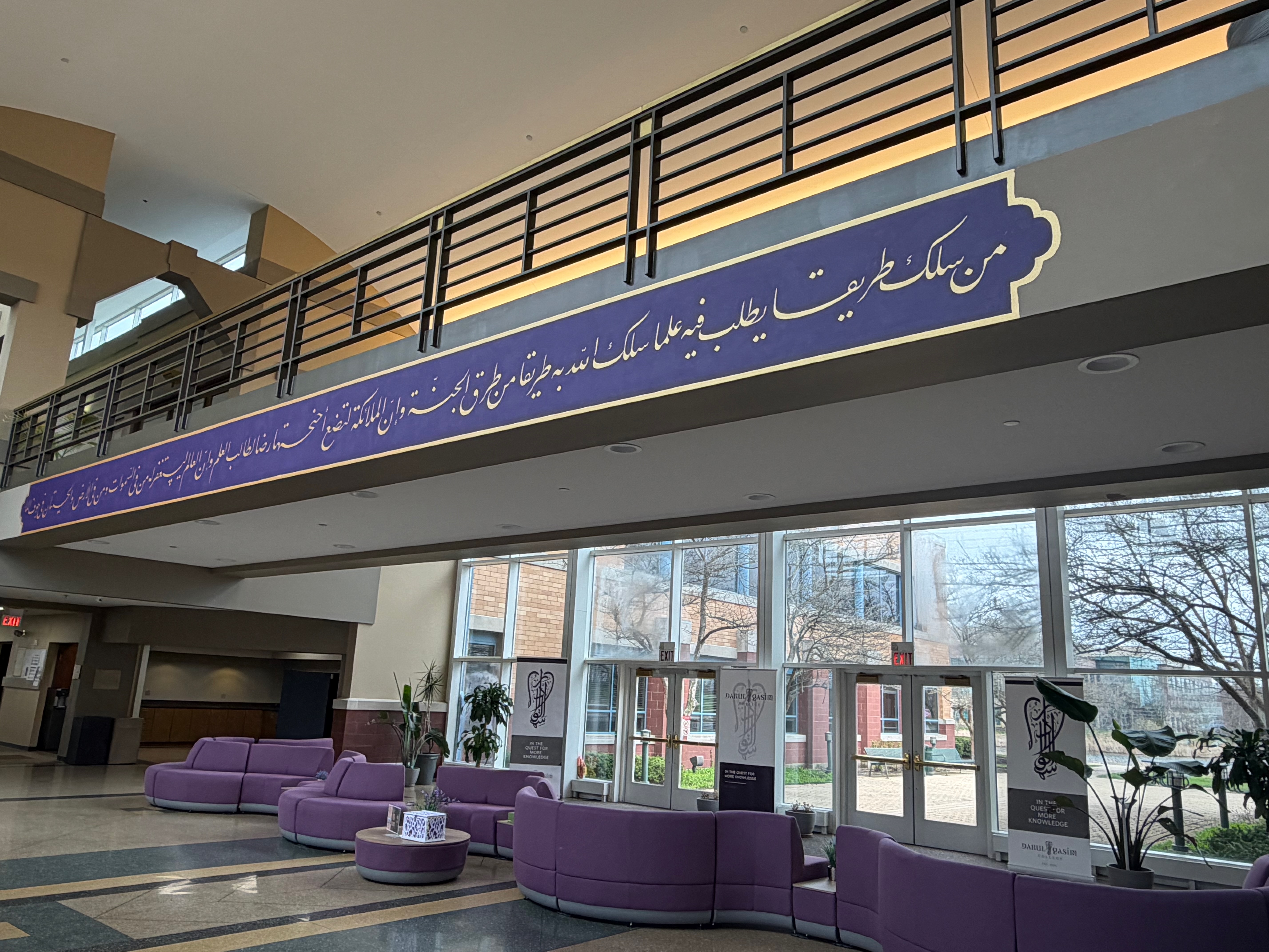 An Arabic calligraphy banner in Darul Qasim's lobby quotes a hadith describing the pursuit of knowledge as a path to paradise
