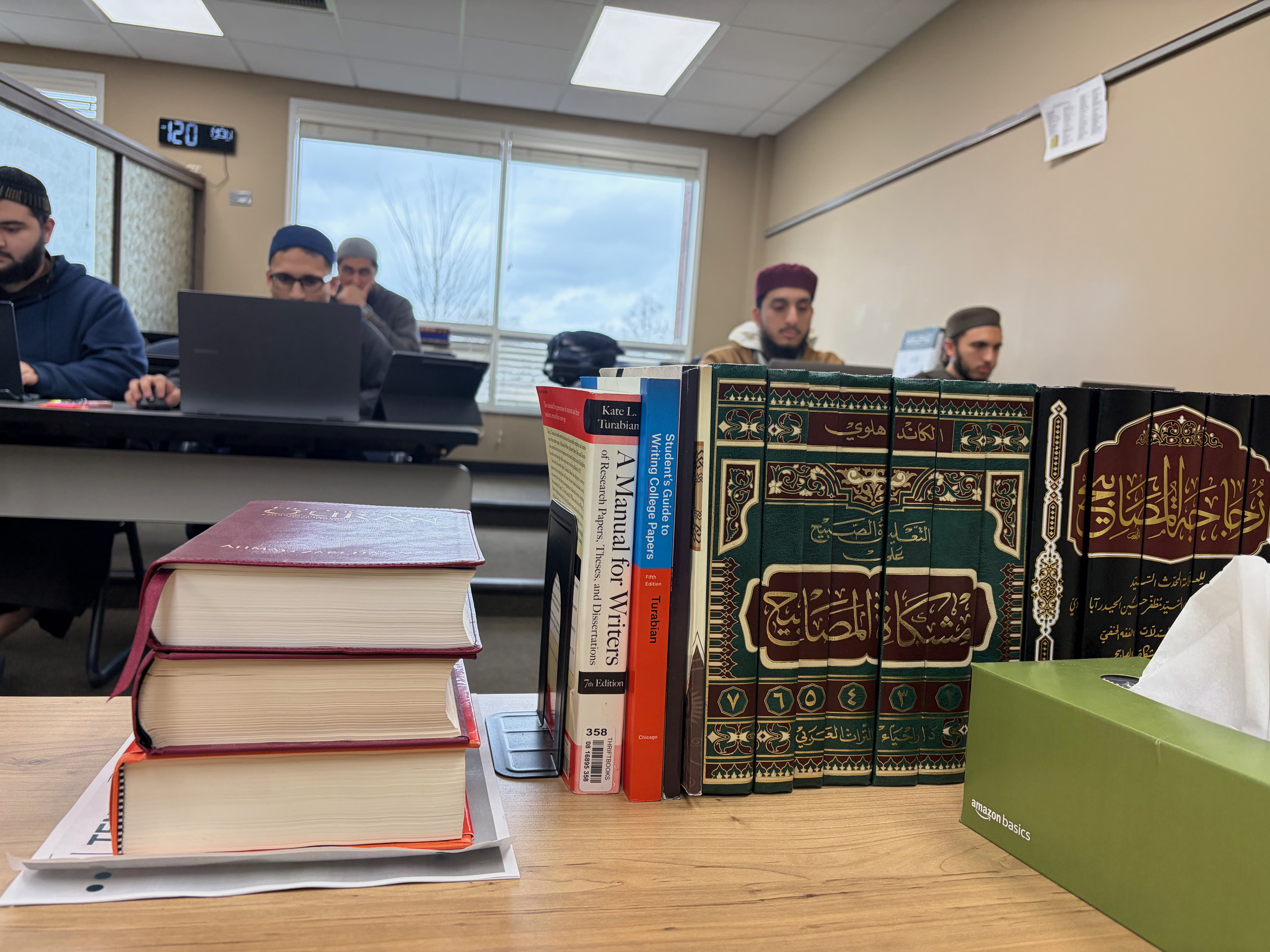 Books on Islamic law, theology and ethics sit on a desk at Darul Qasim, where a growing number of professionals are returning to classical scholarship