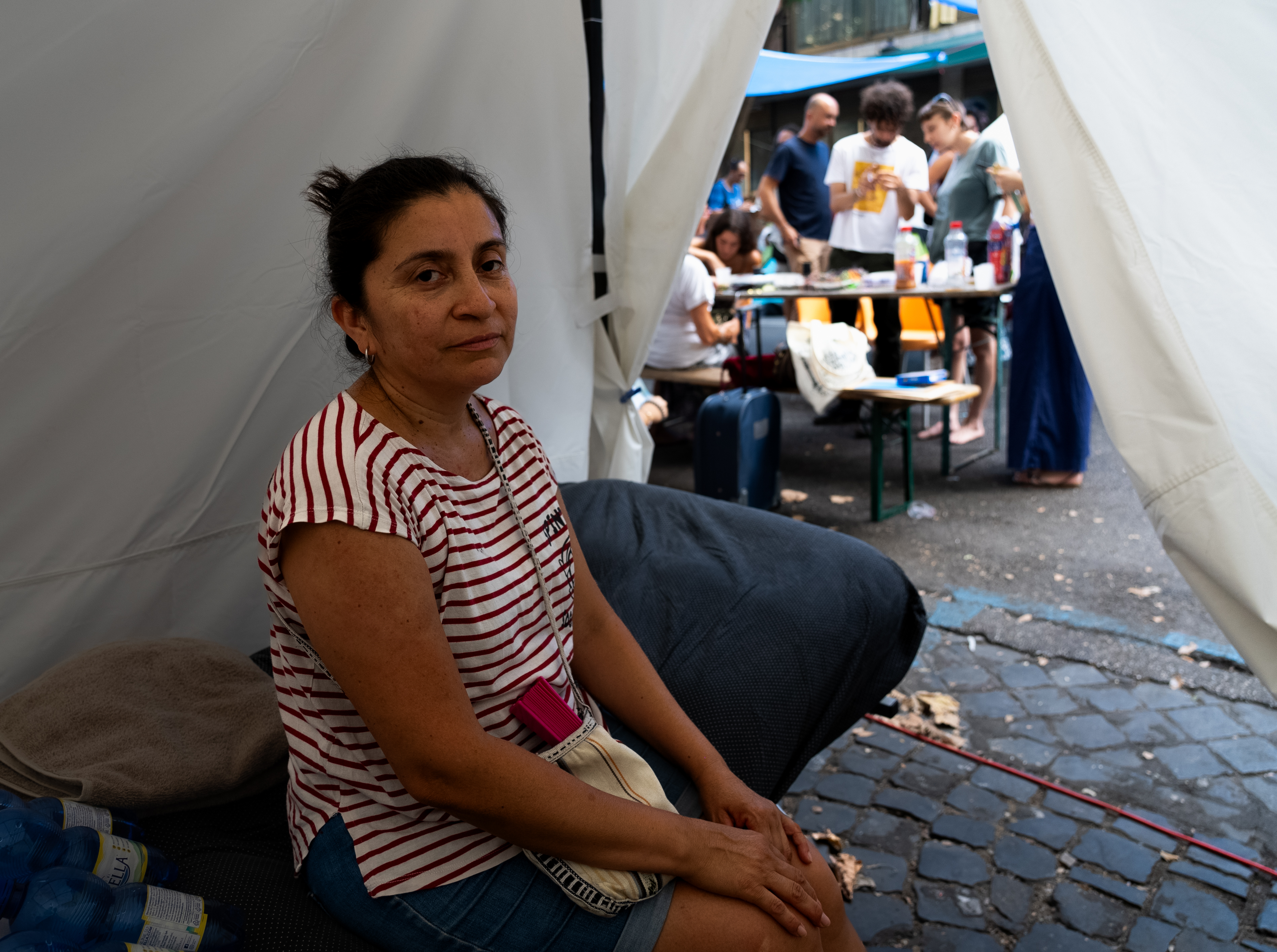 A woman sits in a tent.