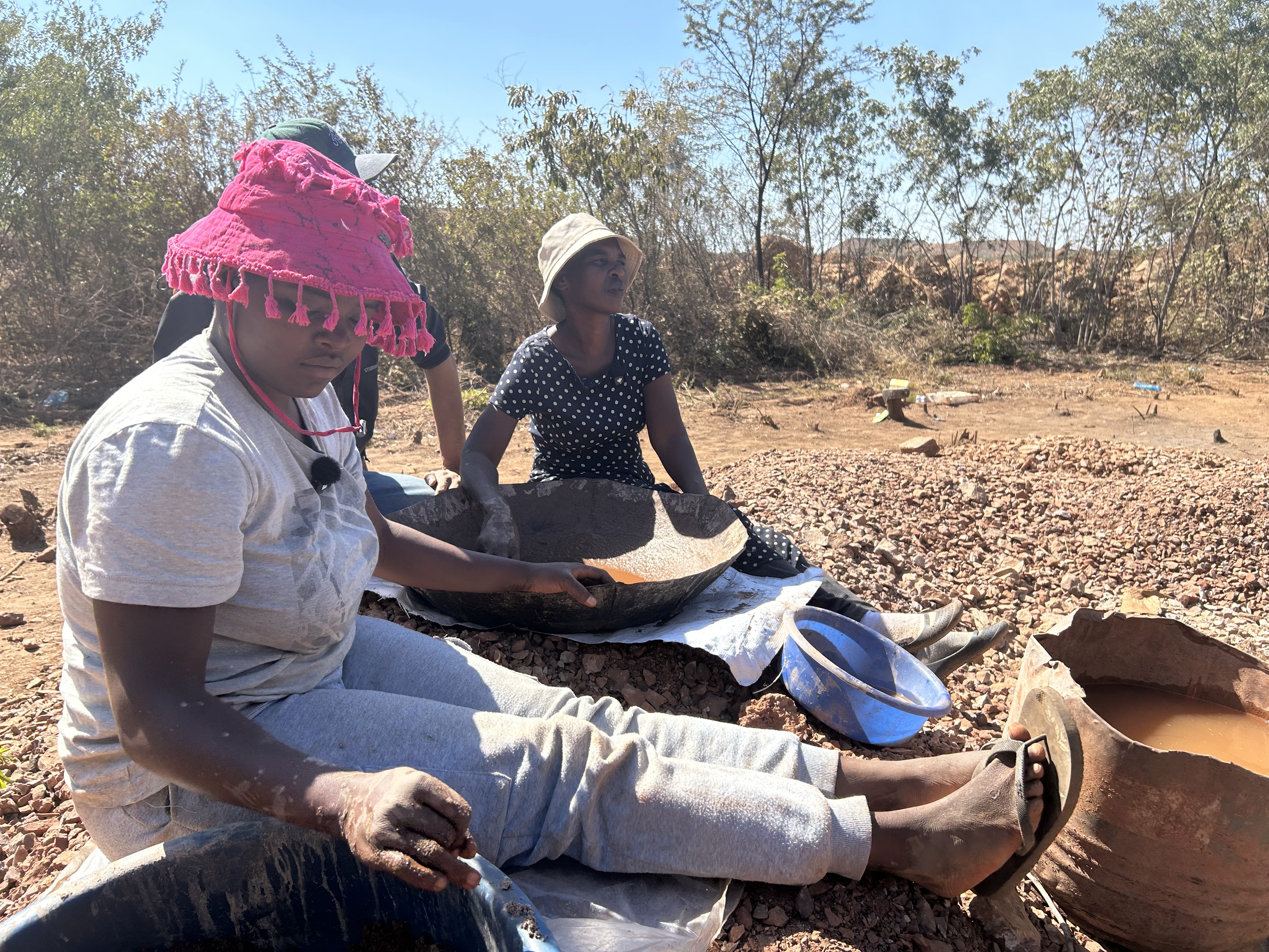 Women who once worked on commercial farms now earn a living as artisanal miners on former agricultural land near Kwekwe, Zimbabwe, reflecting the economic and social changes that followed land redistribution [Calvin Manika/Al Jazeera]