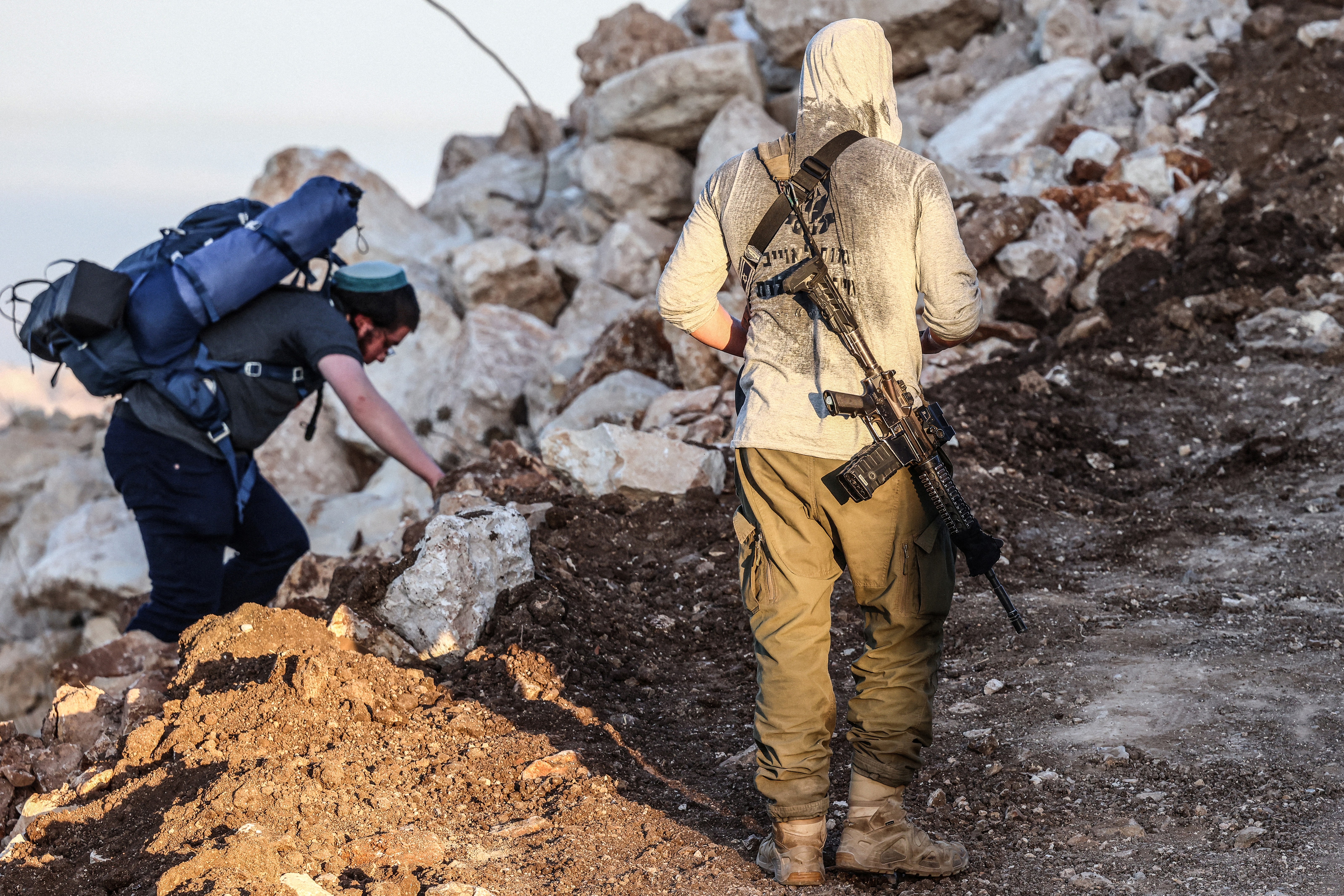 Israeli armed settlers take part in an organised march between the Palestinian villages of Sarra and Tell, southwest of the city of Nablus in the Israeli- occupied West Bank, in memory of two Israelis killed last week during clashes involving settlers entering the village of Tell, on July 31, 2026.
