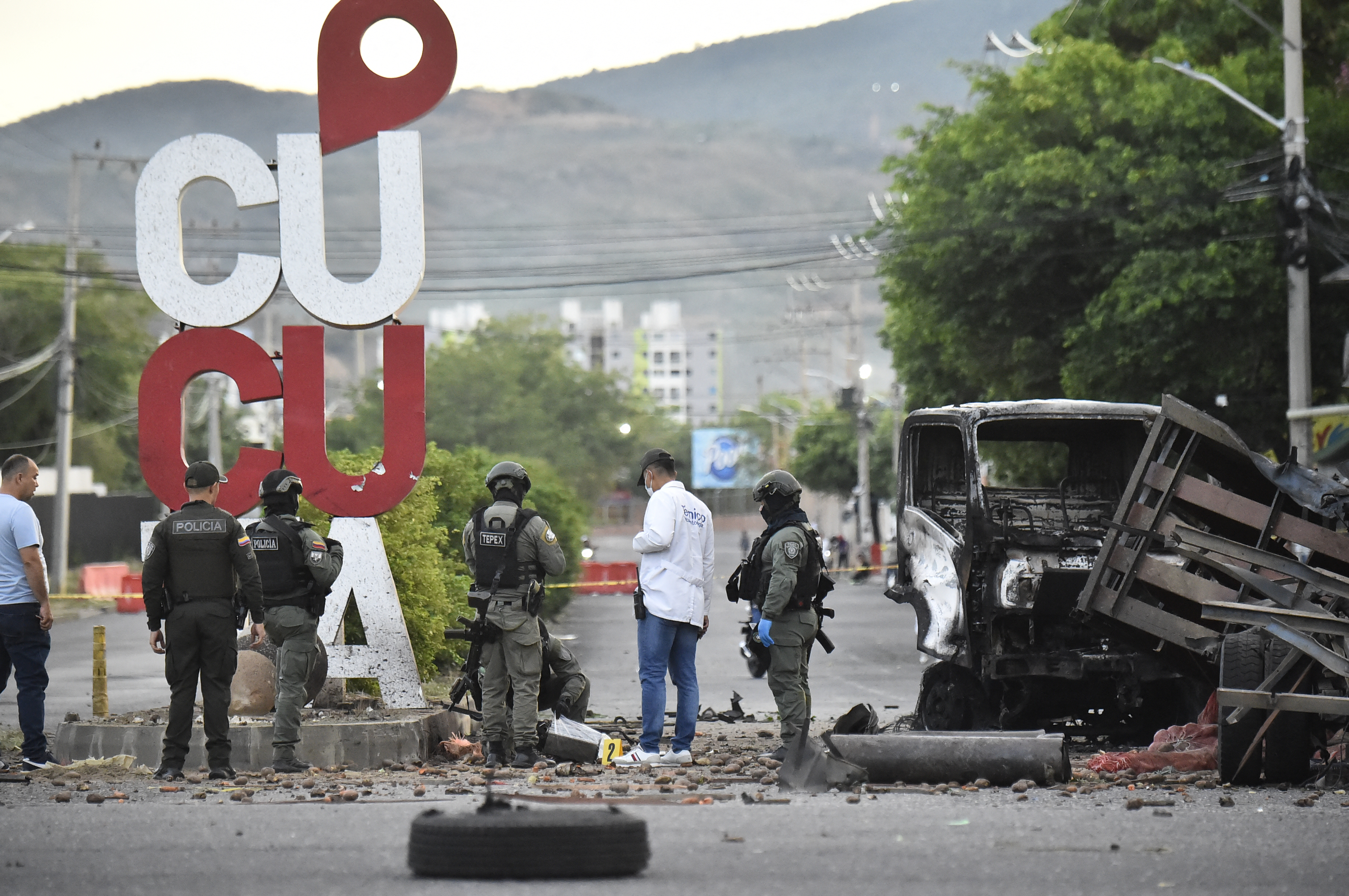 Forensic investigators and police officers examine debris at the site of a car bomb explosion near a police station in Cucuta, Colombia, on August 1, 2026.