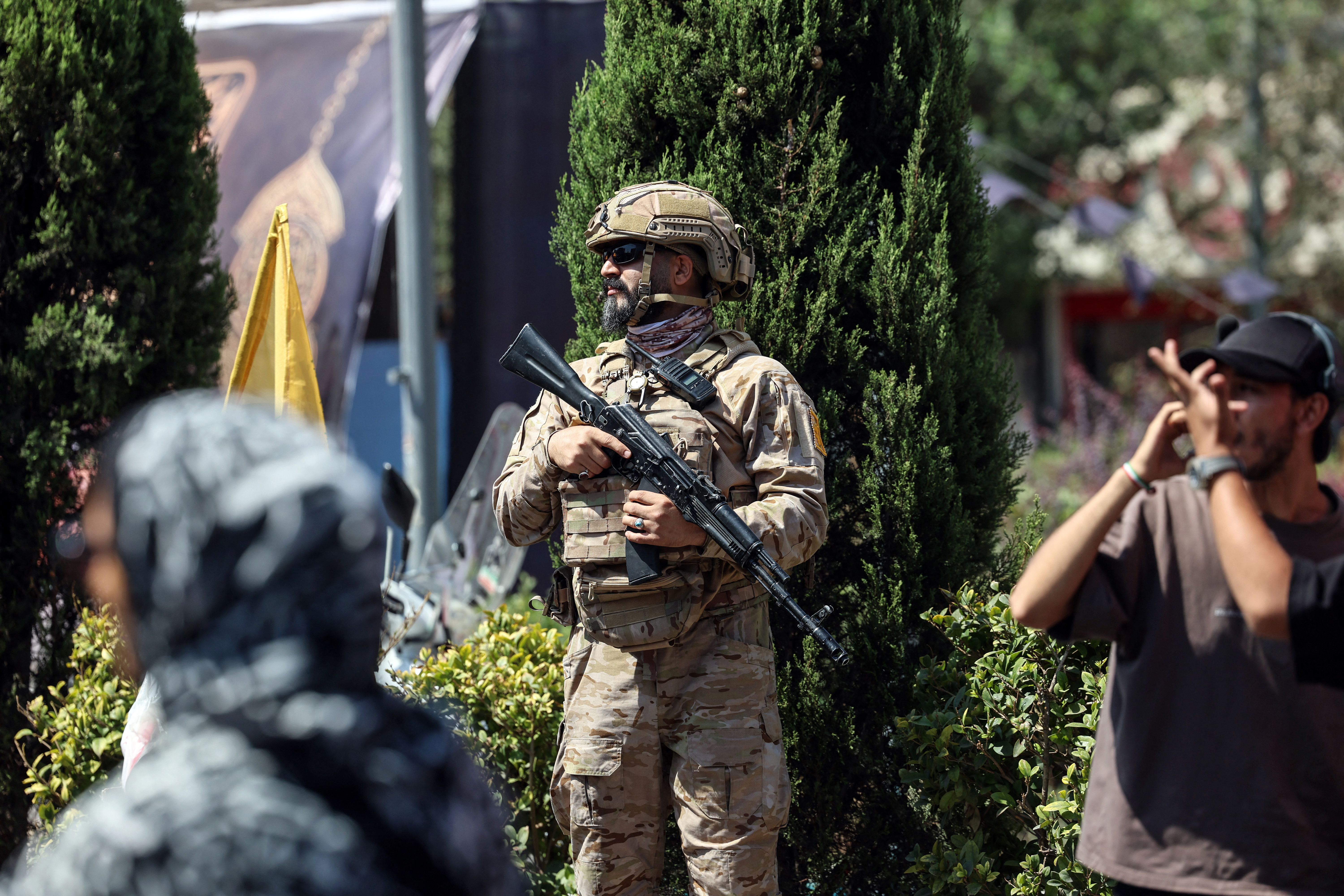 A member of the security forces stands guard as Shia Muslim devotees take part in a mourning procession marking Arbaeen in Tehran on August 4, 2026.