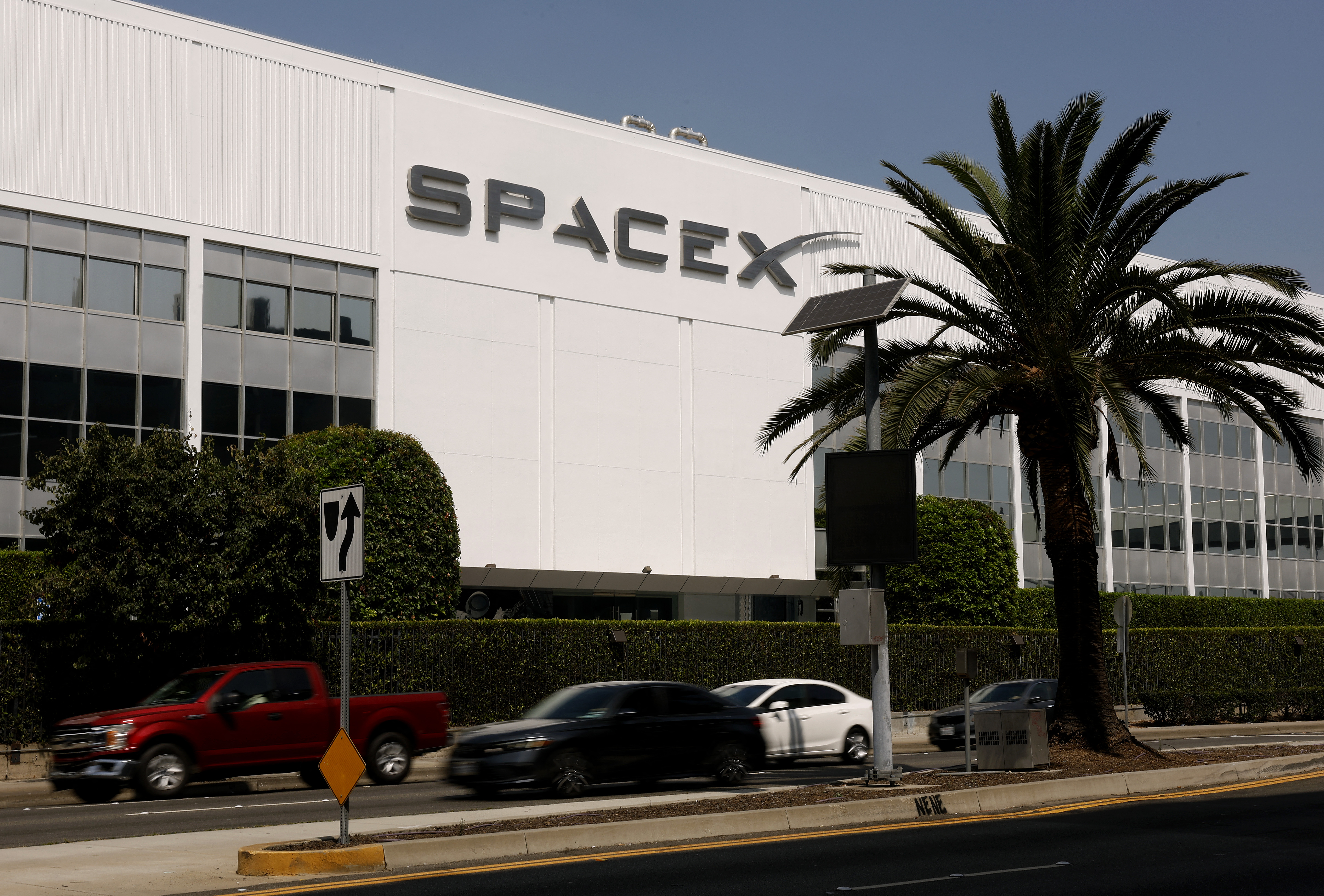 HAWTHORNE, CALIFORNIA - AUGUST 04: The SpaceX logo is displayed at a SpaceX facility on August 04, 2026 in Hawthorne, California. SpaceX is set to release its first earnings report since its June IPO today after the closing bell, with analysts focused on the company's Starlink growth, AI spending and guidance as shares have fallen sharply from their post-IPO highs. Justin Sullivan/Getty Images/AFP (Photo by JUSTIN SULLIVAN / GETTY IMAGES NORTH AMERICA / Getty Images via AFP)