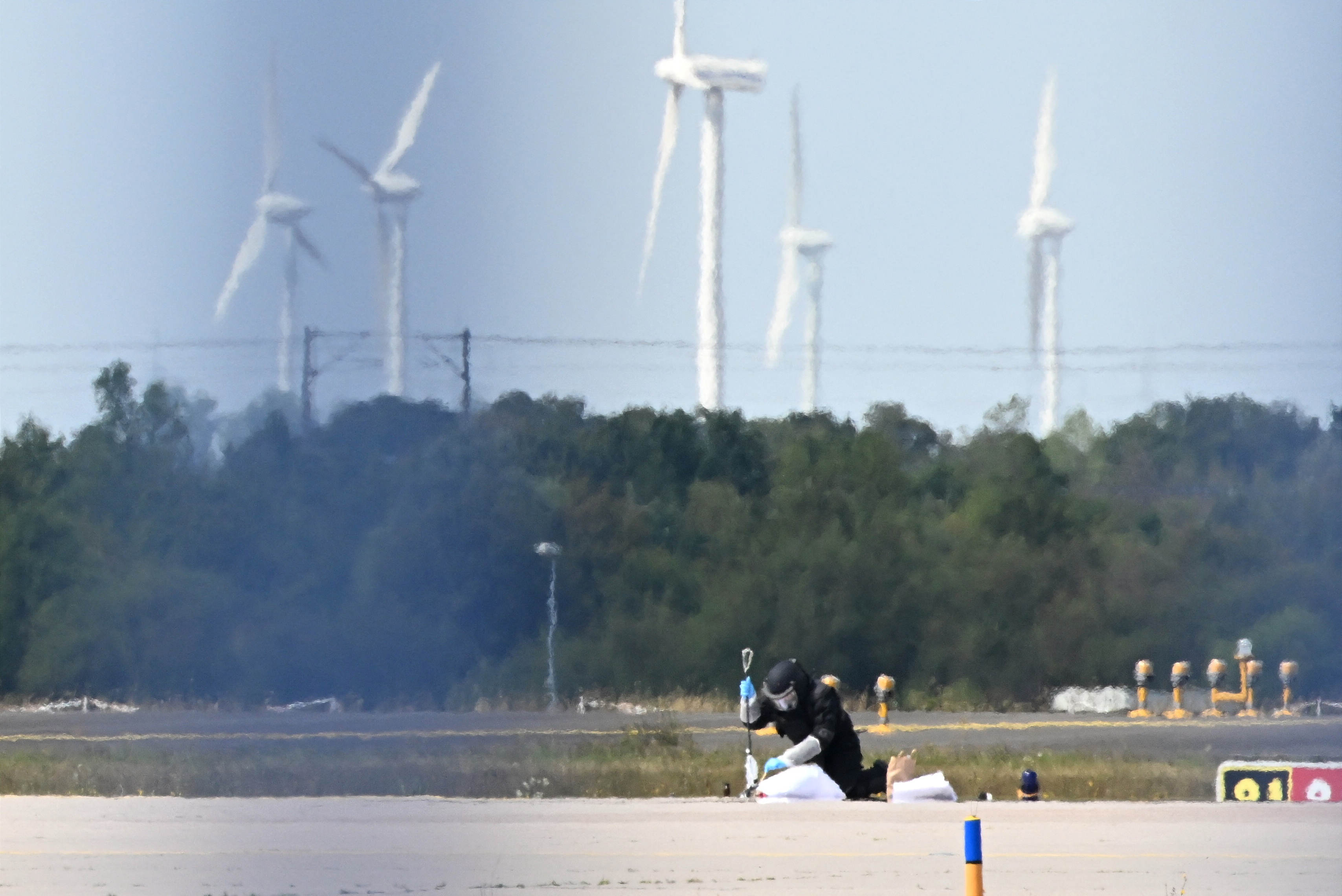 A forensic technician works at the German airport Leipzig-Halle in Schkeuditz, eastern Germany, after an explosives-laden drone was found near a Ukrainian cargo plane [AFP]