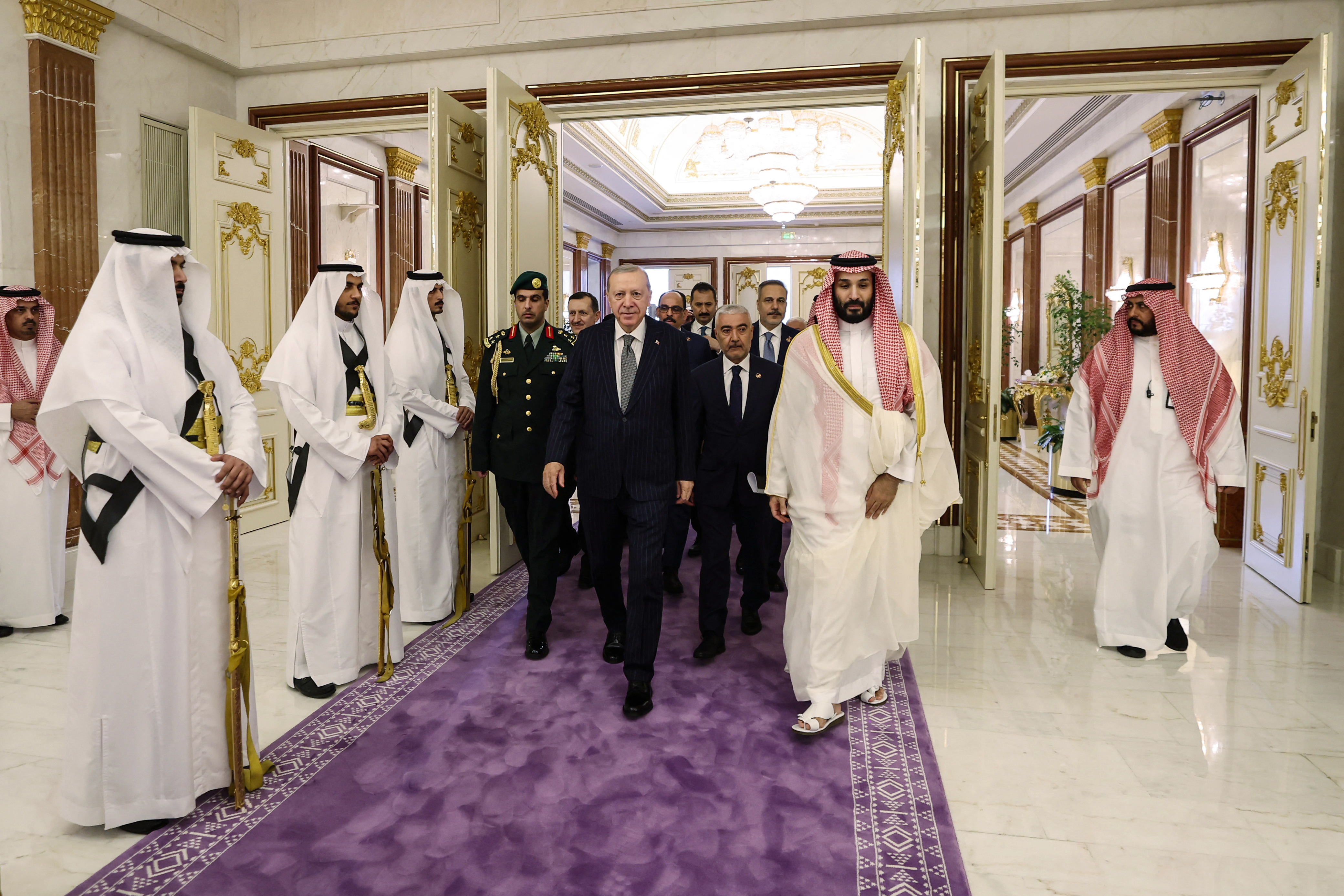 This handout photograph taken and released by the Turkish Presidency press office on August 7, 2026, shows Saudi Arabia's Crown Prince Mohammed bin Salman (C-R) walking alongside Turkey's President Recep Tayyip Erdogan (C) during their meeting in Mecca.