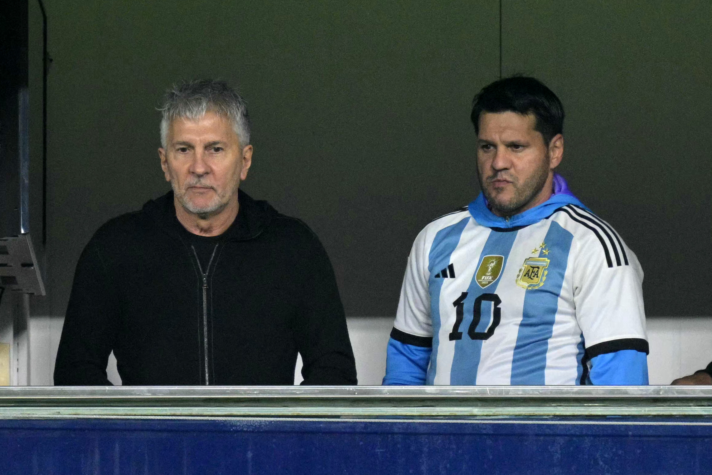 (FILES) Argentina's forward Lionel Messi's father, Jorge Messi (L), and brother Rodrigo wait for the start of the 2026 FIFA World Cup South American qualifiers football match between Argentina and Peru at the La Bombonera stadium in Buenos Aires on November 19, 2024.