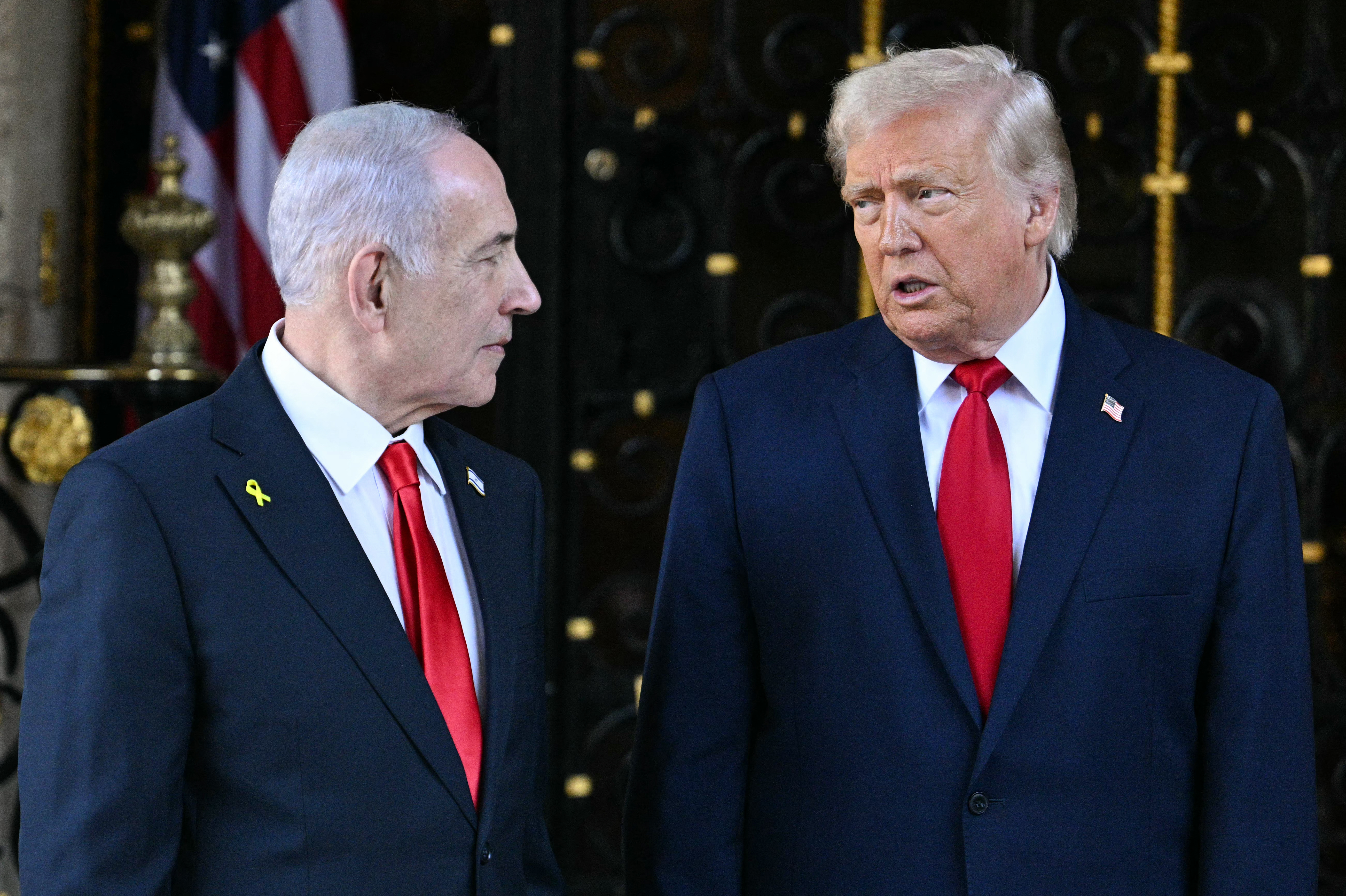 (FILES) US President Donald Trump (R) greets Israeli Prime Minister Benjamin Netanyahu (L) upon arrival at Trump’s Mar-a-Lago residence in Palm Beach, Florida, on December 29, 2025.