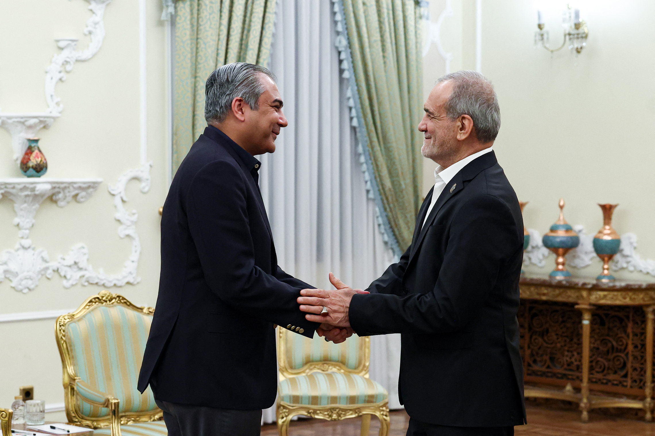 A handout photo made available by the Iranian Presidency shows Iranian President Masoud Pezeshkian (R) greeting Pakistan's Minister of Interior Syed Mohsin Raza Naqvi (L) during their meeting in Tehran on August 11, 2026. (Photo by Iranian Presidency / AFP) / RESTRICTED TO EDITORIAL USE - MANDATORY CREDIT "AFP PHOTO / IRANIAN PRESIDENCY" - HANDOUT - NO MARKETING NO ADVERTISING CAMPAIGNS - DISTRIBUTED AS A SERVICE TO CLIENTS