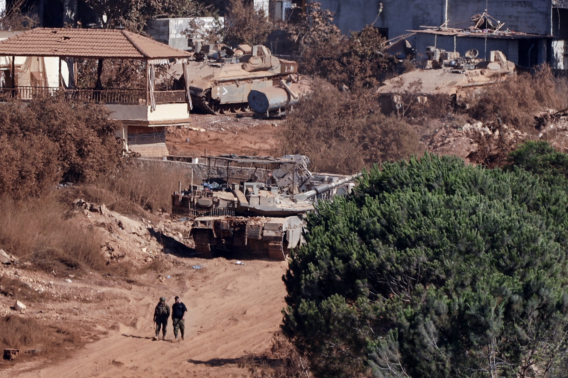 TOPSHOT - A photograph taken from the southern Lebanese viallage of of Zawtar al-Gharbiyah shows Israeli troops stationed in the nearby village of Zawtar al-Charkiyah on August 11, 2026.
