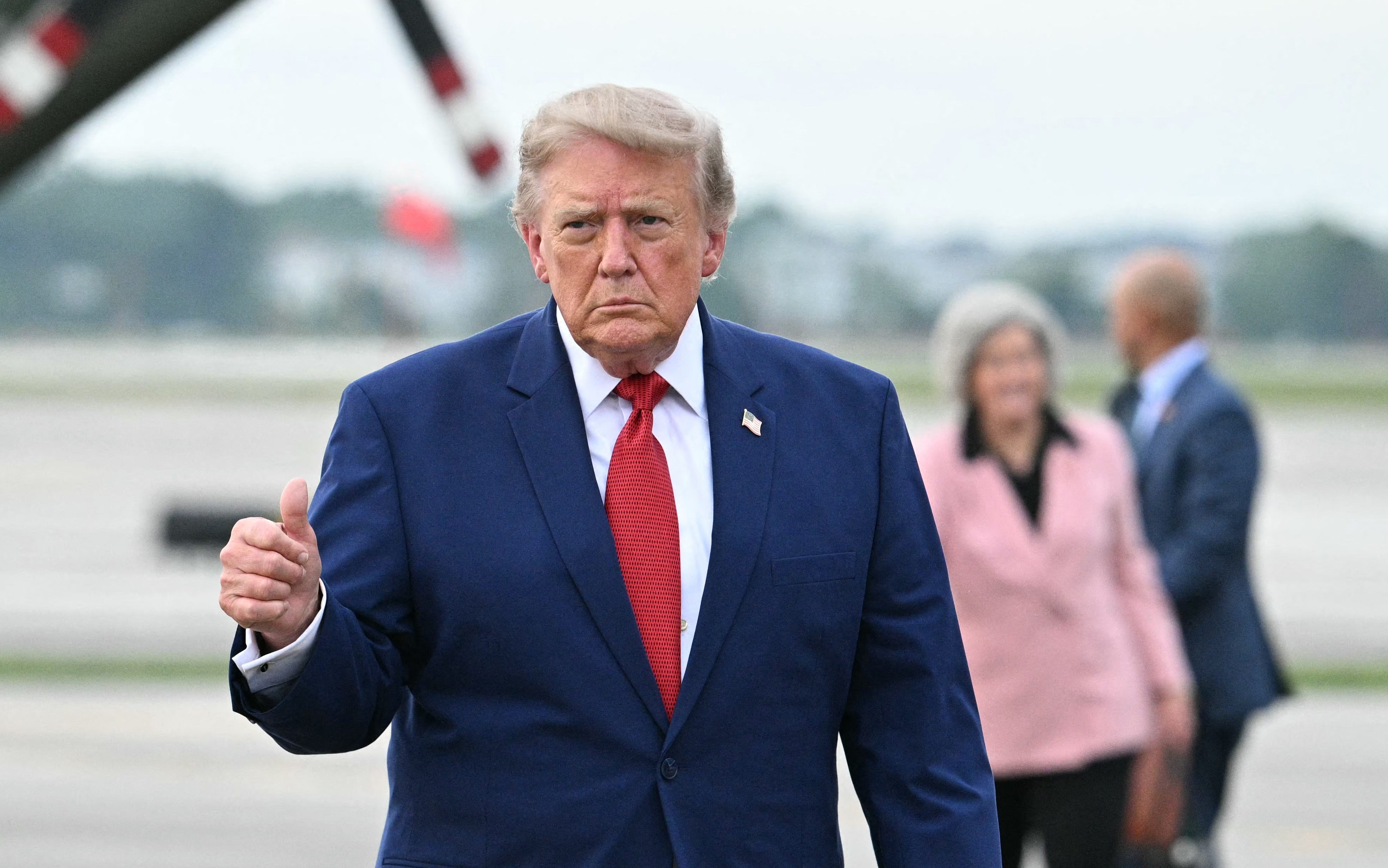 US President Donald Trump gives a thumbs up before boarding Air Force One en route back to Washington, DC, at Cleveland Hopkins International Airport in Cleveland, Ohio on August 11, 2026.