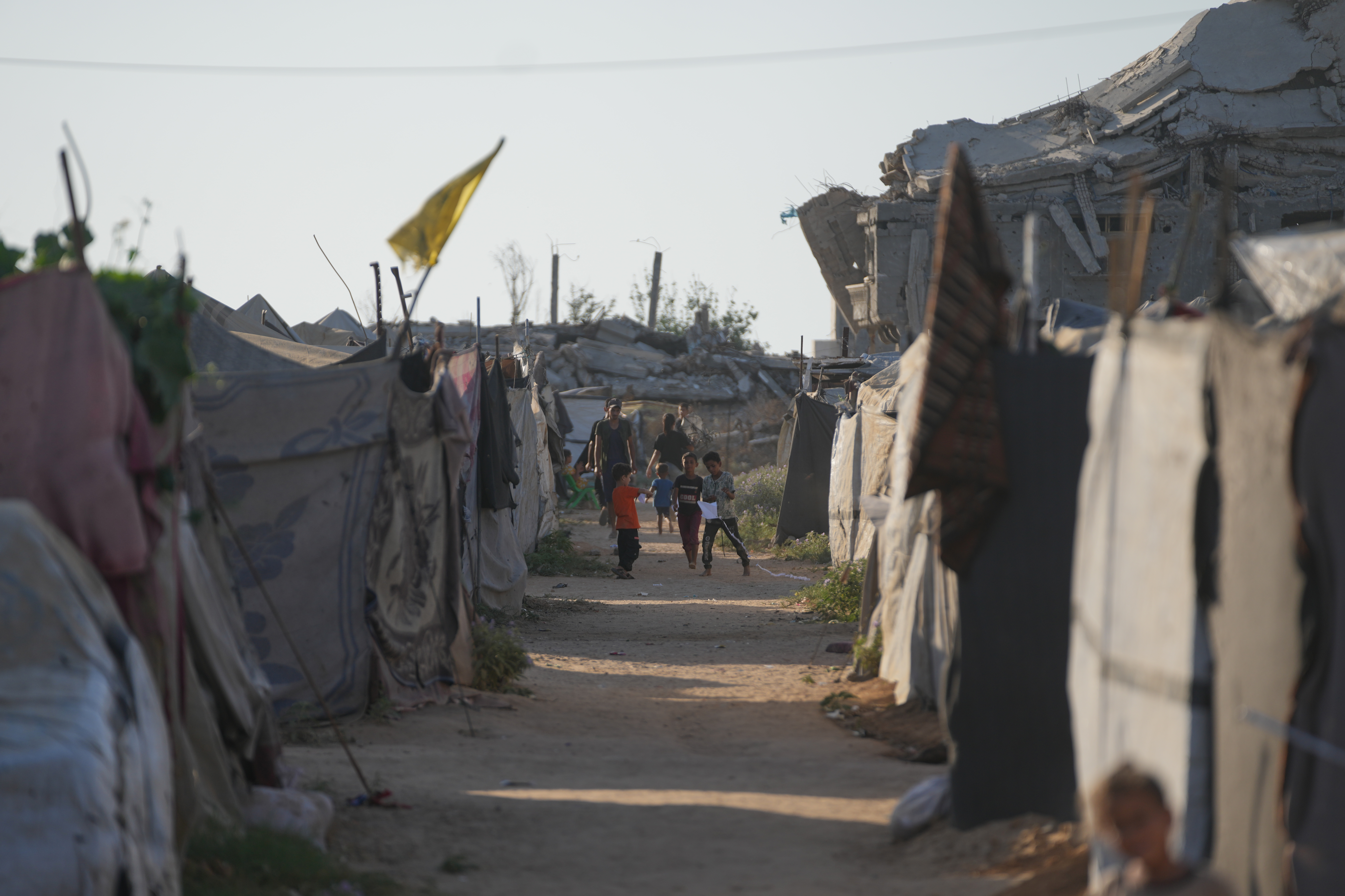Children play in a tent camp for displaced Palestinians in Nuseirat, central Gaza Strip Friday, July 31, 2026. (AP Photo/Abdel Kareem Hana)
