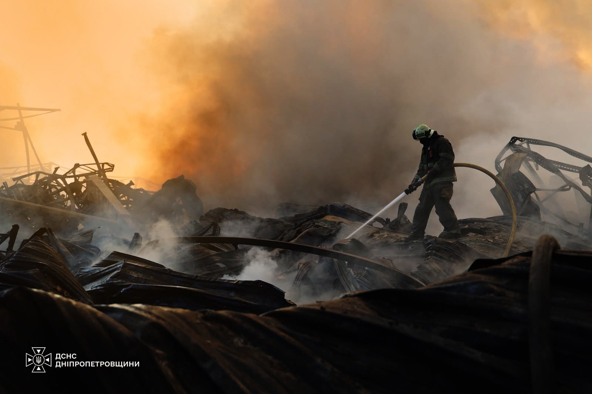 A firefighter puts out a blaze.