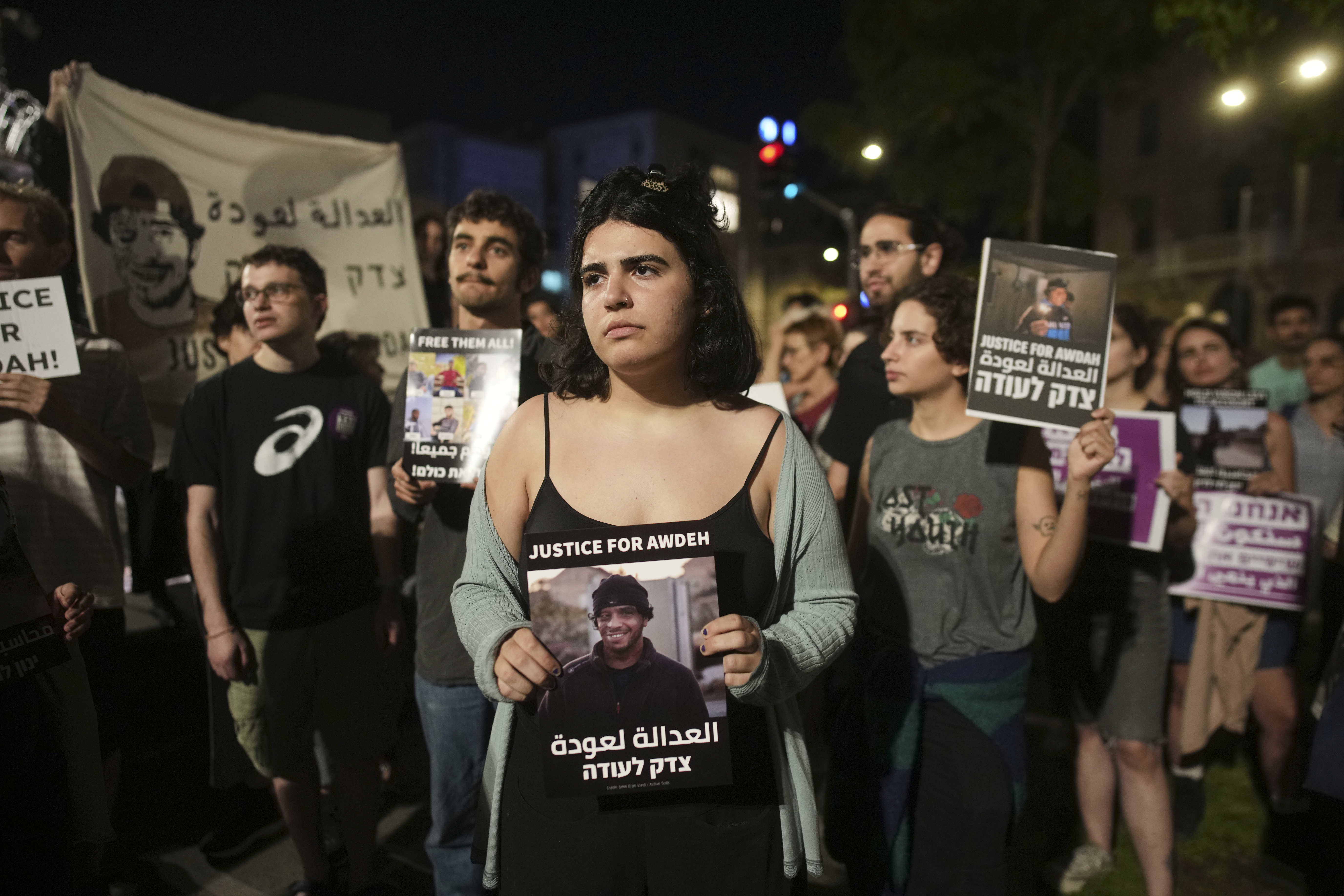 Activists protest while calling for the release of the body of Awdah al-Hathaleen, a Palestinian killed last week in South Hebron Hills, West Bank, and whose body is being held by Israel, as well as other village residents still held in custody, Sunday, Aug. 3, 2025, in Jerusalem. (AP Photo/Ohad Zwigenberg)
