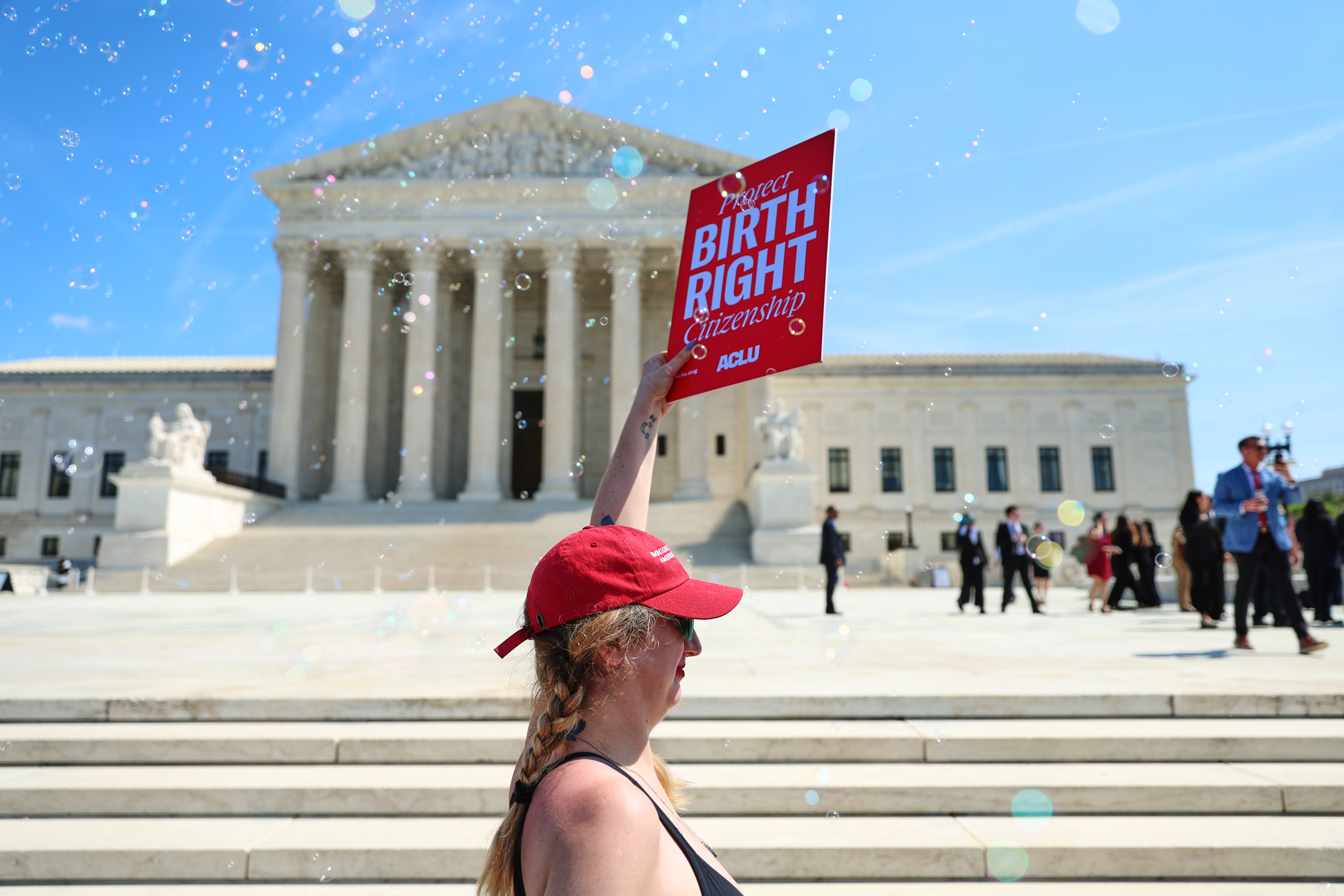 Demonstrators rally outside the U.S. Supreme Court after justices hear oral arguments on whether President Donald Trump can deny citizenship to children born to parents who are in the United States illegally or temporarily, on Capitol Hill in Washington, Wednesday, April 1, 2026. (AP Photo/Tom Brenner)