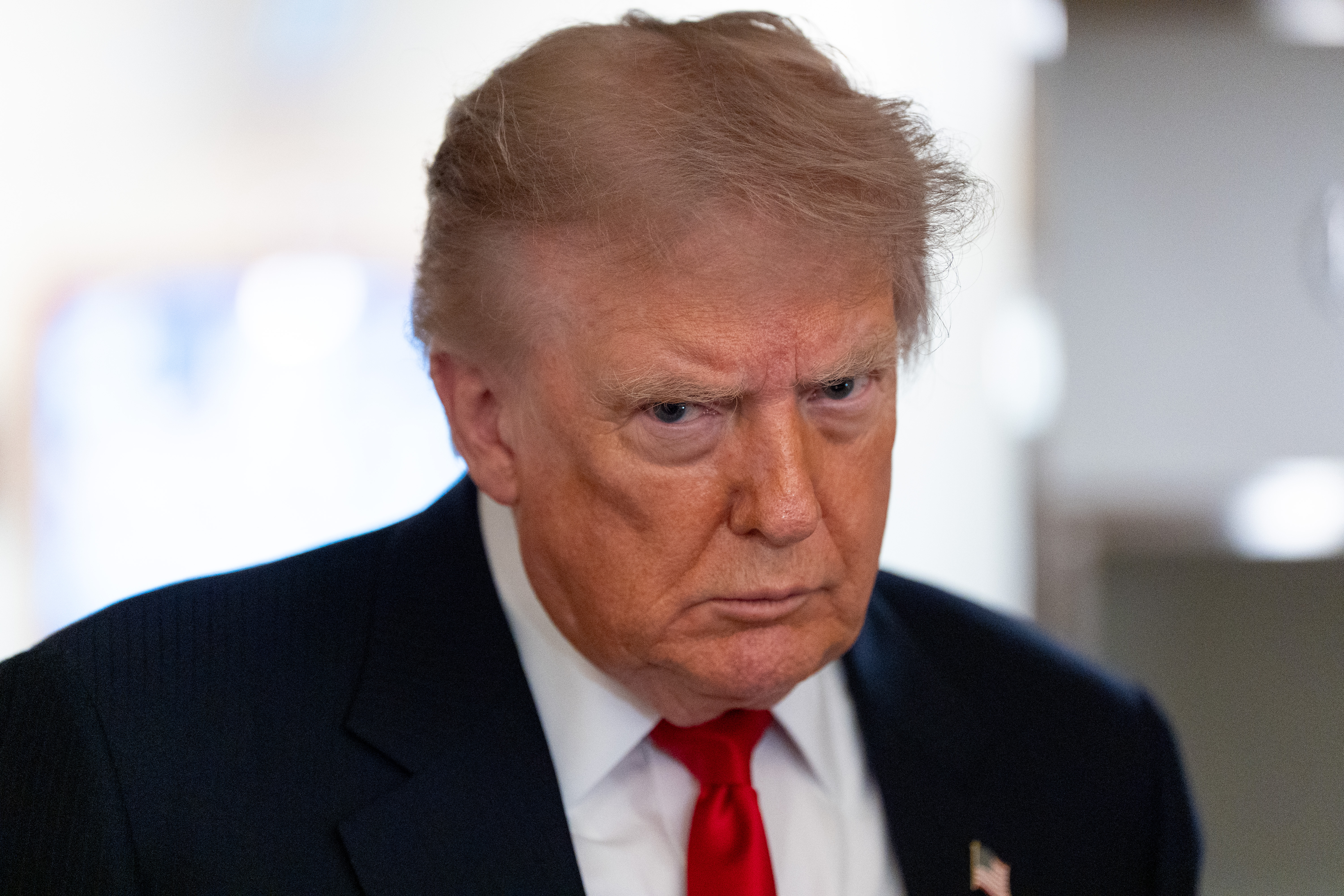 FILE - President Donald Trump speaks with reporters while on Air Force One en route to Oakland County International Airport, July 27, 2026, in Waterford Township, Mich. (AP Photo/Alex Brandon, File)