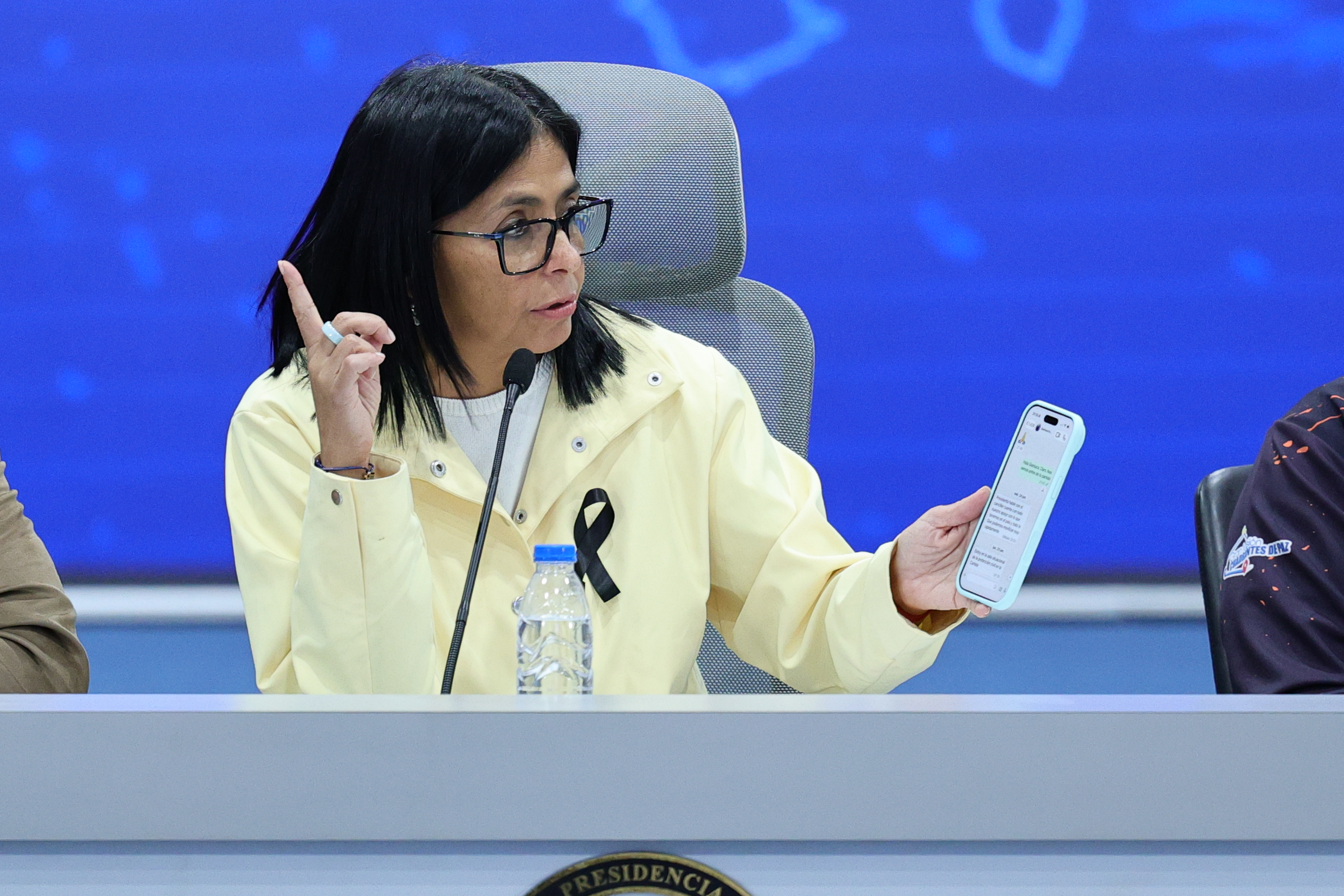 CARACAS, VENEZUELA - JULY 2: Delcy Rodriguez, Venezuela's interim president, shows her phone with a conversation during a press conference regarding the situation in Venezuela after the double earthquake that struck the country at Miraflores Palace on July 2, 2026 in Caracas, Venezuela. According to the U.S. Geological Survey (USGS), the main earthquake on June 24, 2026 was followed by a 7.5-magnitude aftershock less than a minute later. The number of fatal victims increased to 2595, while the number of injured people exceeded 12,000. More than 70,000 people are reported missing. (Photo by Jesus Vargas/Getty Images)