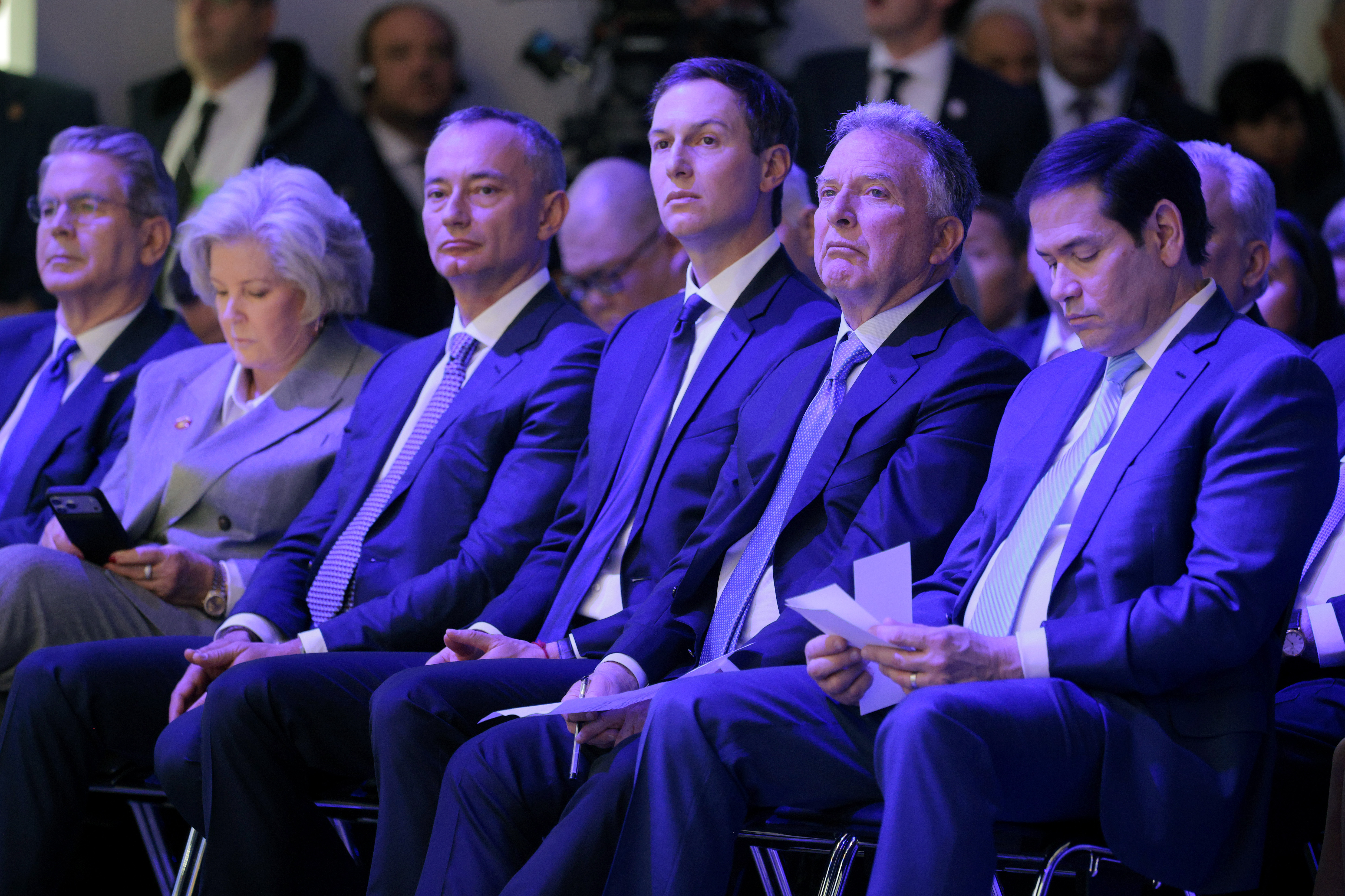 DAVOS, SWITZERLAND - JANUARY 22: (L-R) United States Secretary of the Treasury Scott Bessent, White House Chief of Staff Susie Wiles, former UN Middle East envoy Nickolay Mladenov, Donald Trump's son-in-law Jared Kushner, United States Special Envoy to the Middle East Steve Witkoff and United States Secretary of State Marco Rubio watch as U.S. President Donald Trump presents the “Board of Peace” onstage at the World Economic Forum (WEF) on January 22, 2026 in Davos, Switzerland. The US-backed “Board of Peace” is intended to administer the fragile ceasefire in the Gaza Strip after the war between Israel and Hamas. The final makeup of the board has not been confirmed. (Photo by Chip Somodevilla/Getty Images)